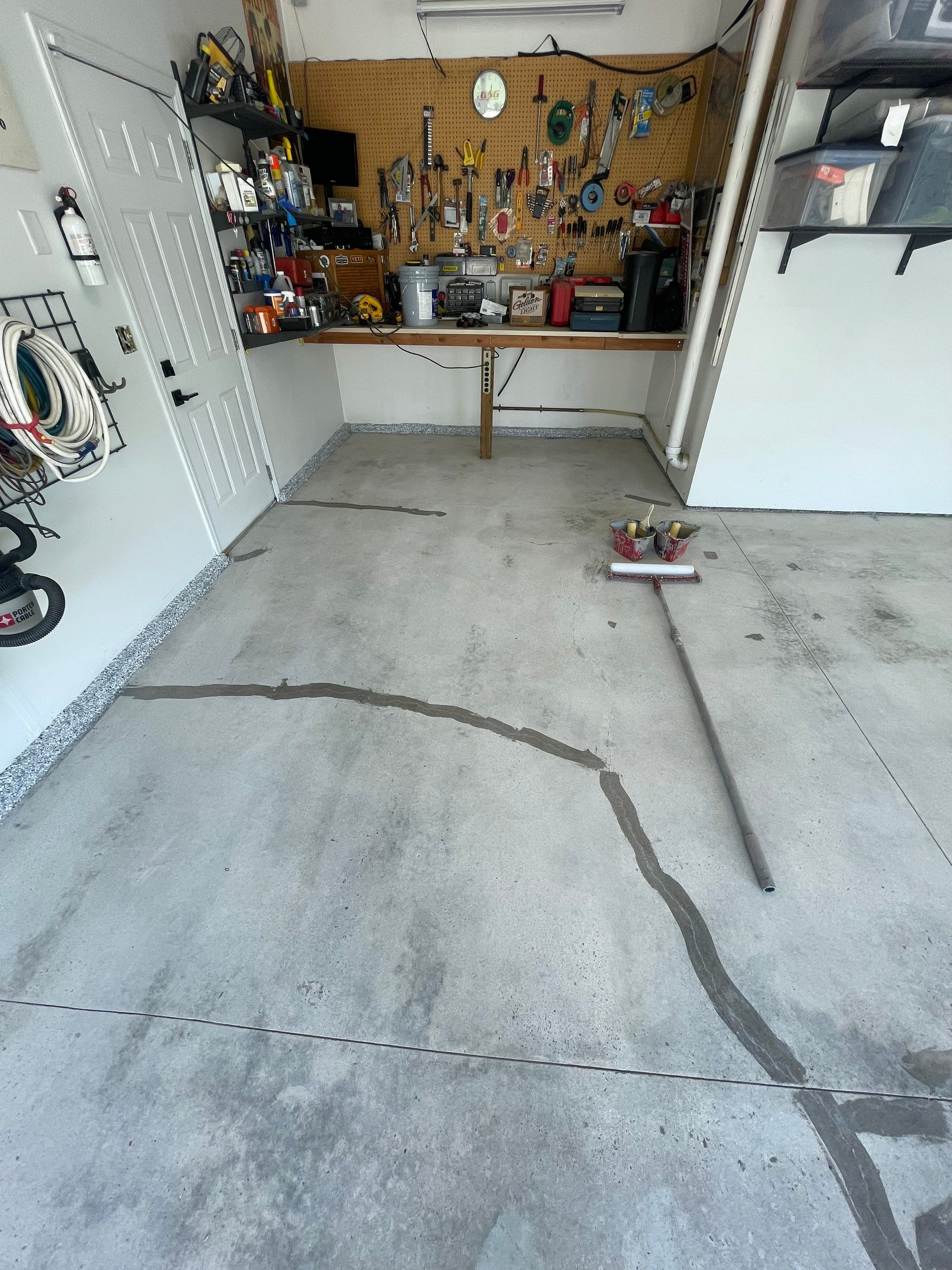 Feather Grey Garage Floor Coating Installation in Sioux Falls by Select Painting, Coatings & Garage Cabinets