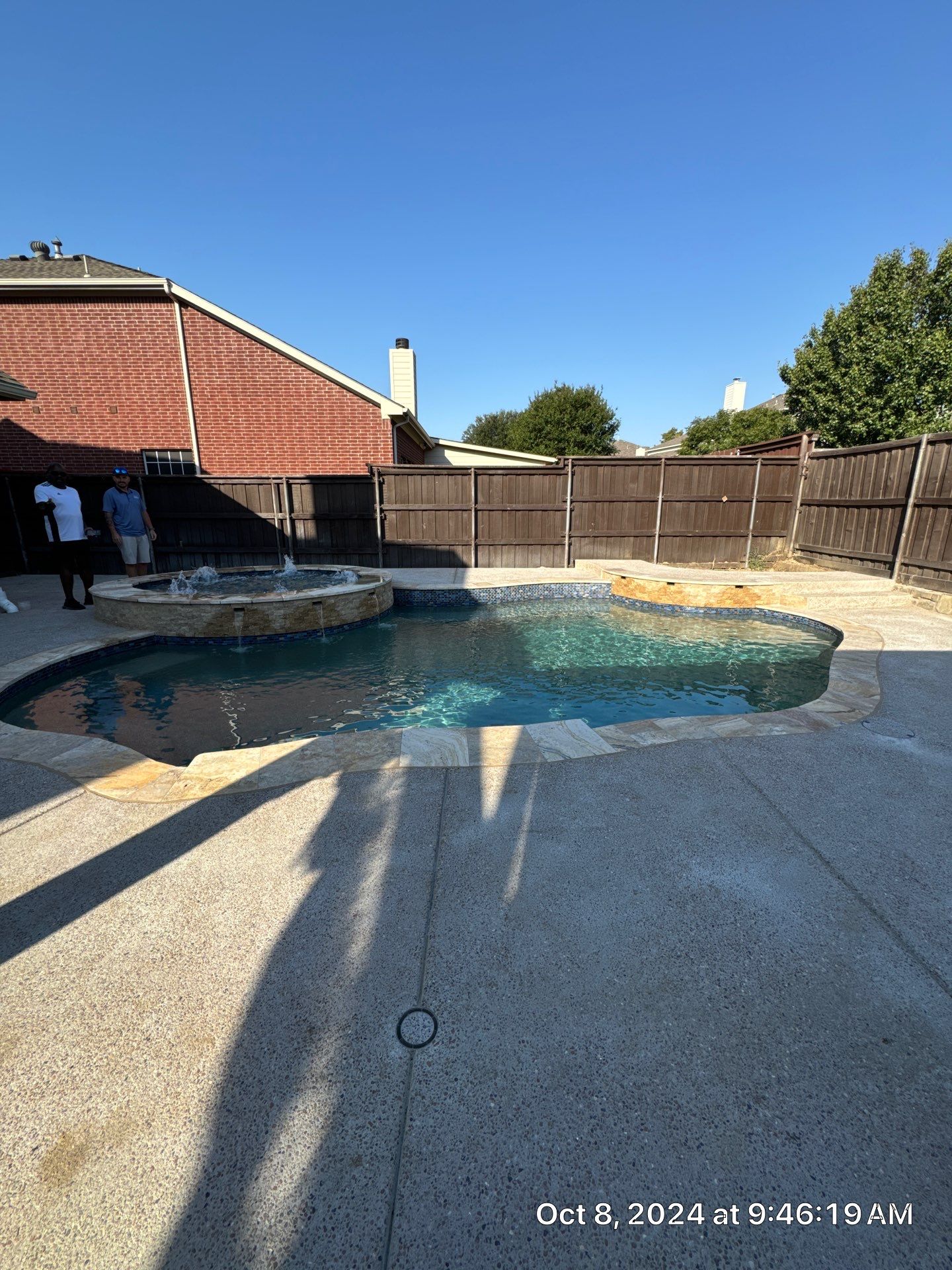 Freeform Pool and Spa with Raised Stone Water Wall by Pinnacle Pools and Spas - DFW