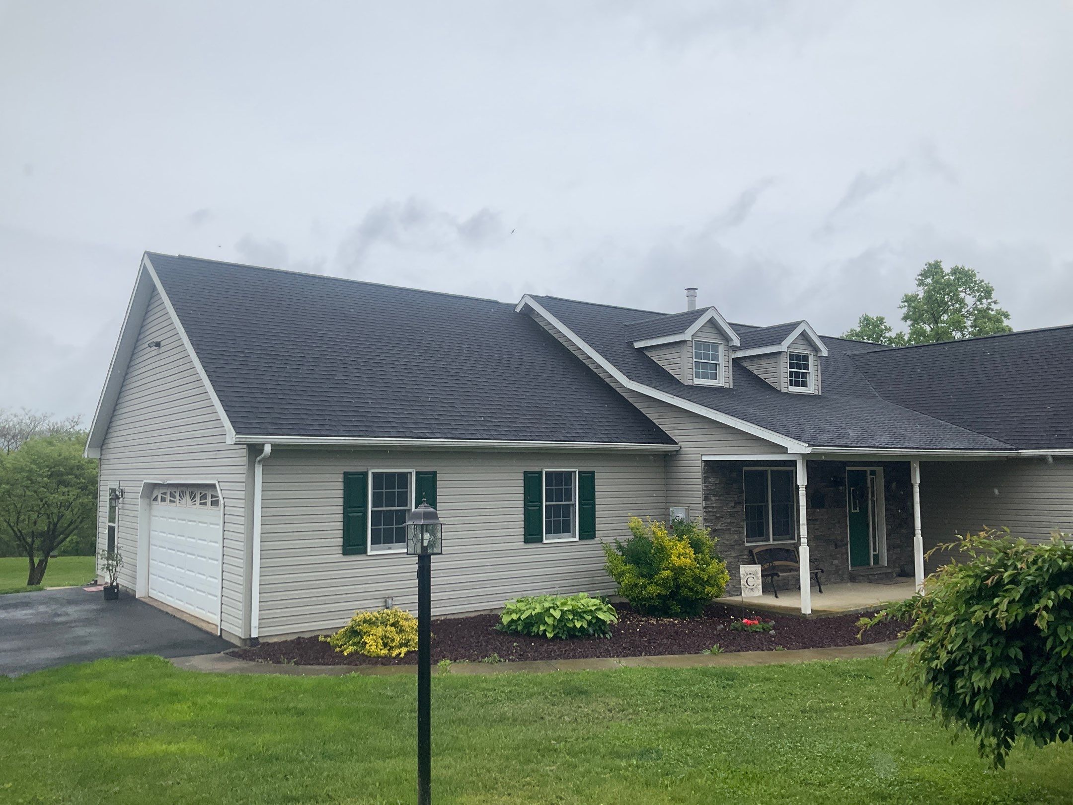 Green Metal Roof and Custom Covered Deck in Duncannon by Esh Builders