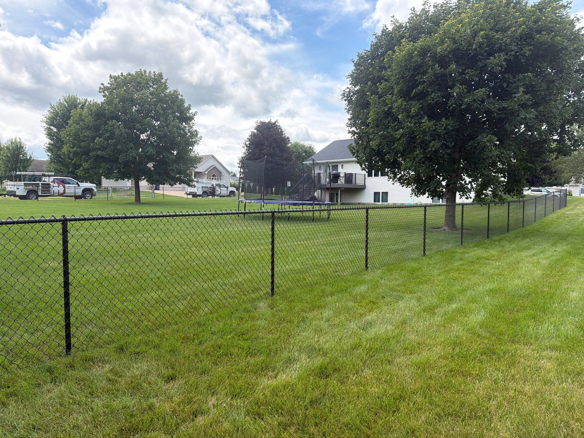 Black Vinyl-Coated Chain Link Fence Installation in Fairbank by Perfect Picket Fence and Stain