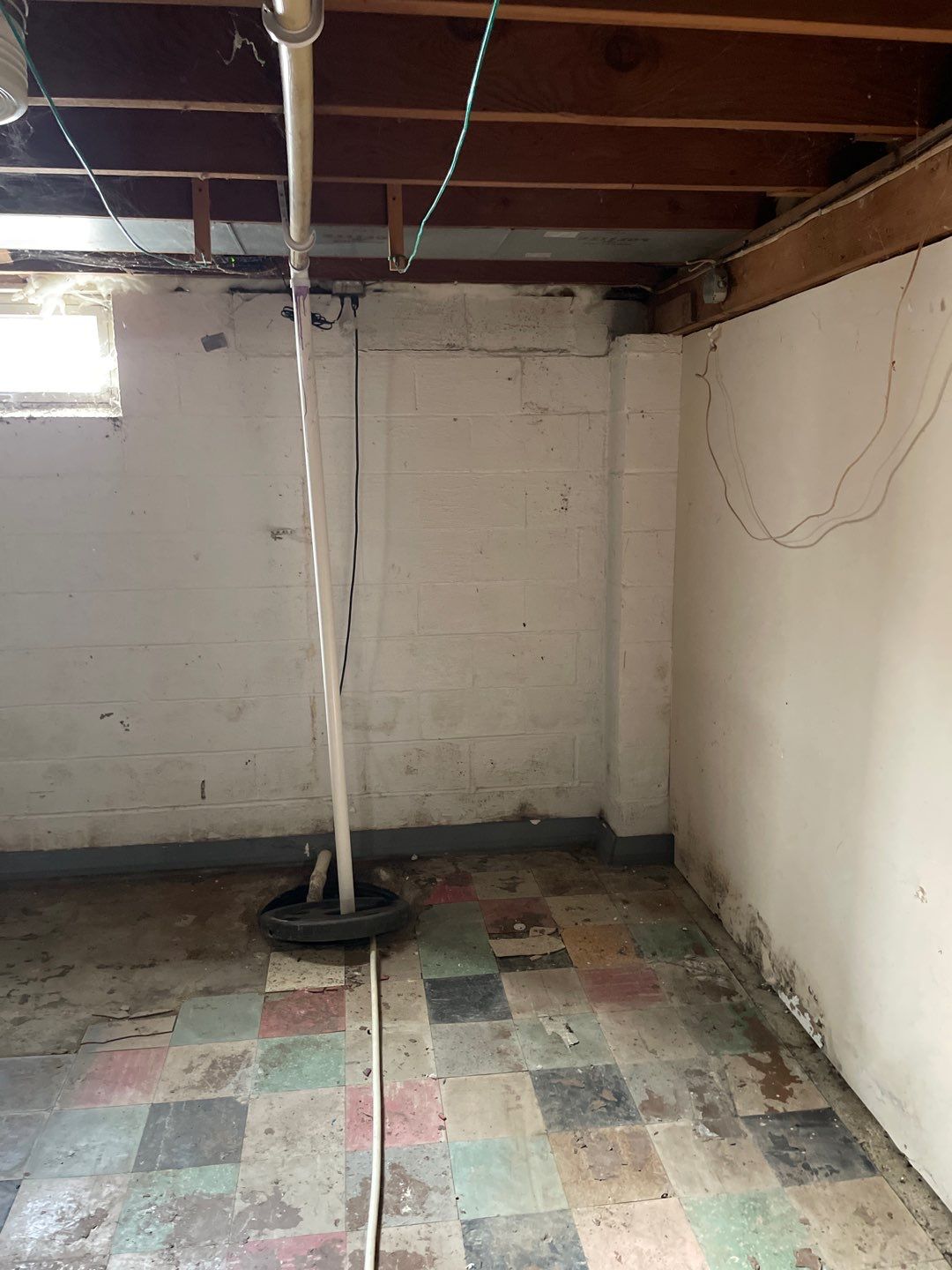 Interior drain tile system installation by ACE Waterproofing & Basement Solutions