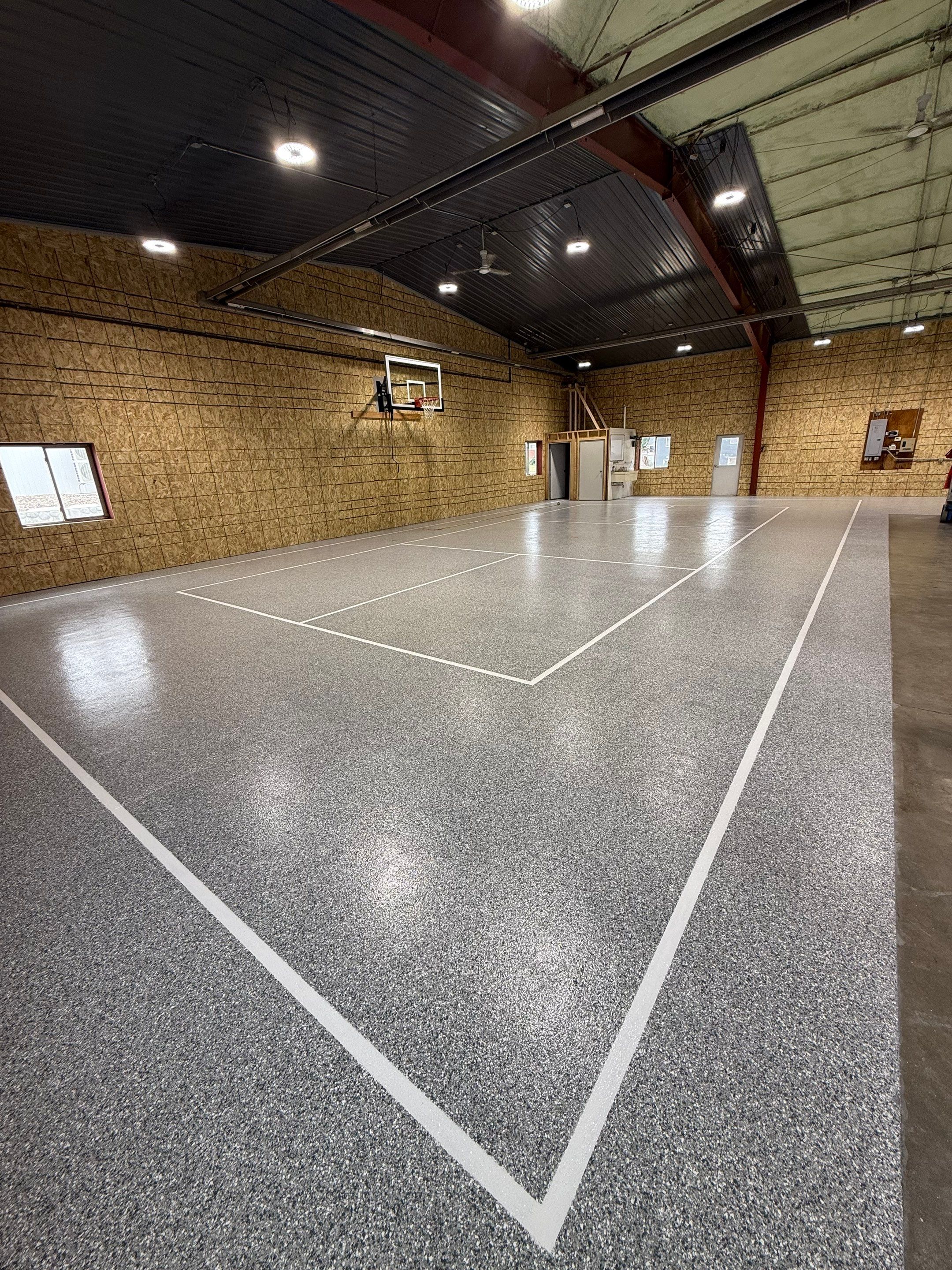 Custom Polyurea Shop Floor with Basketball Court Lines in Rock Valley by Select Painting, Coatings & Garage Cabinets