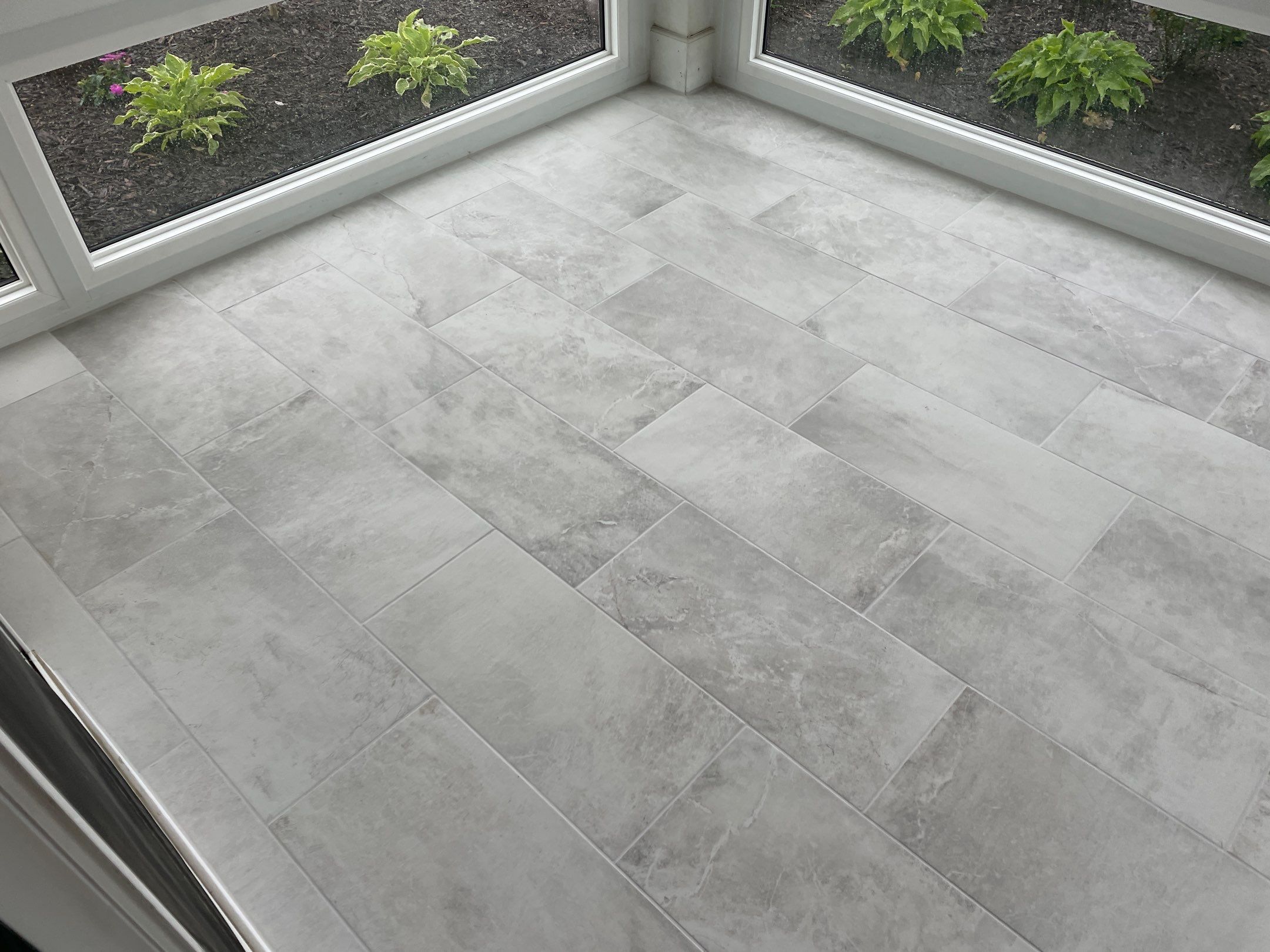Amazing Tile Transformation After Enclosed Windows Added to Sunroom by Footprints Floors of Coastal Carolina