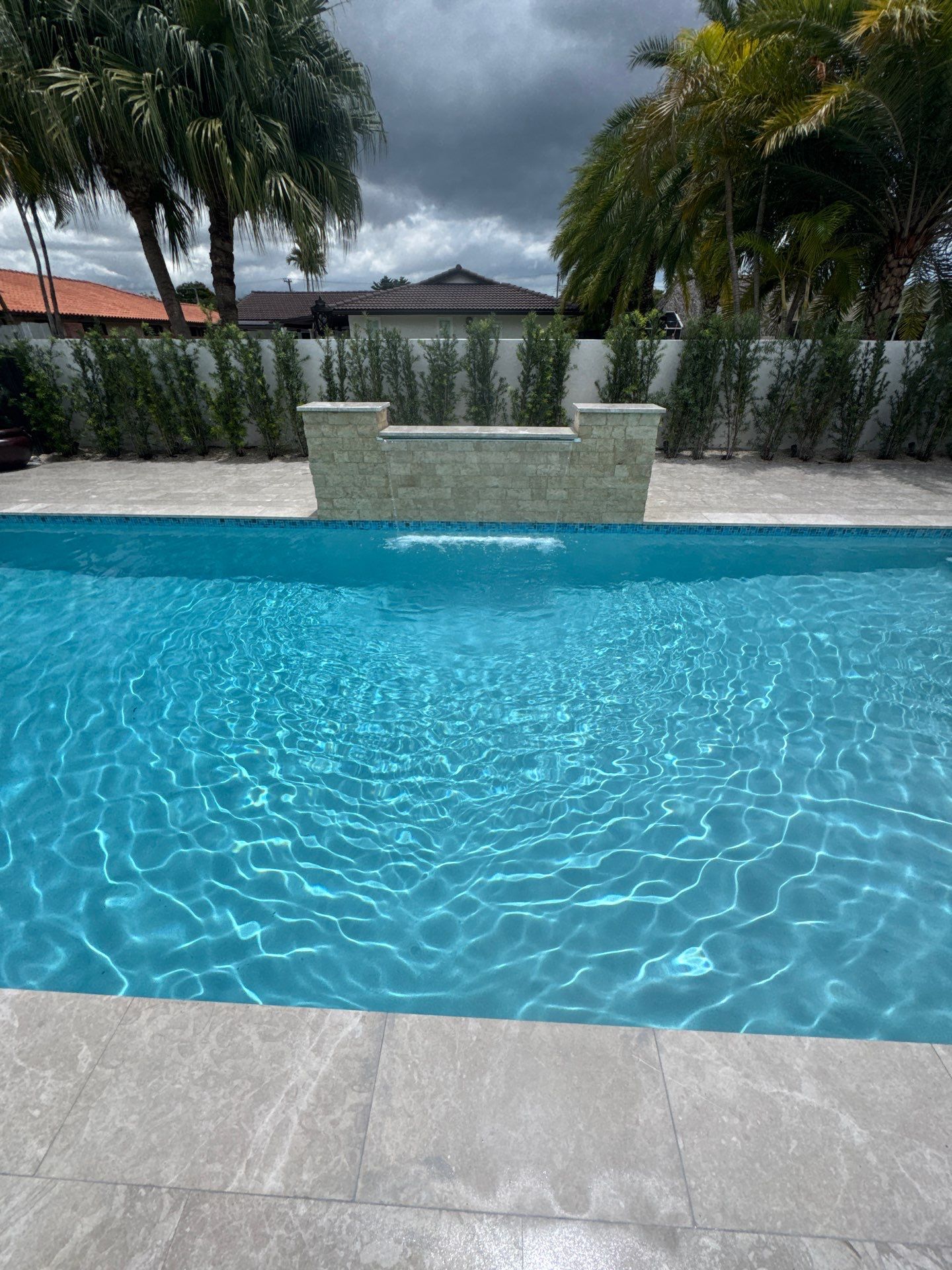 Watefall and bench addition by Pristine Pools Miami