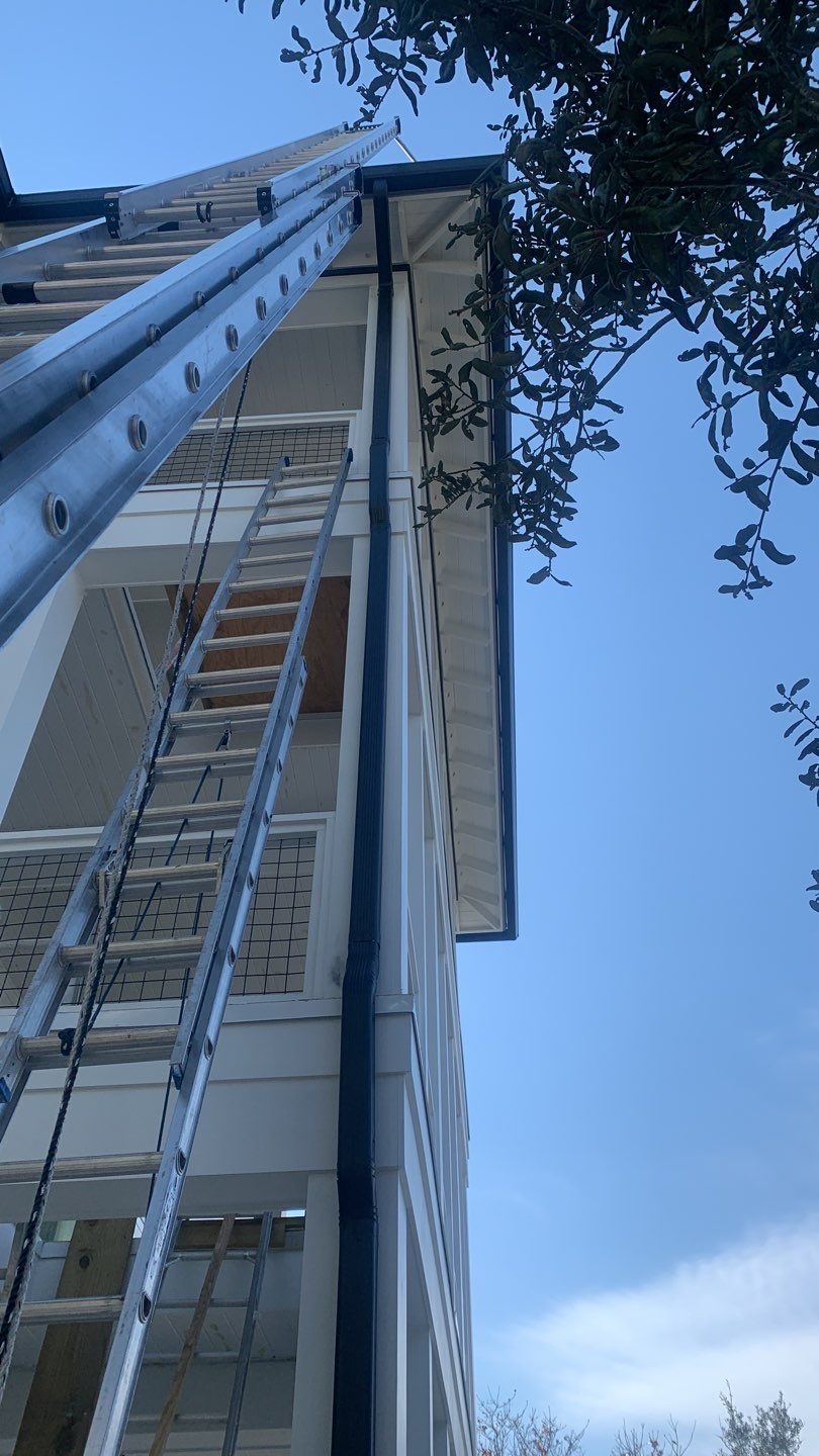 Seamless Gutter Installation Using Black Half Round Seamless Gutters by Gutter Professors