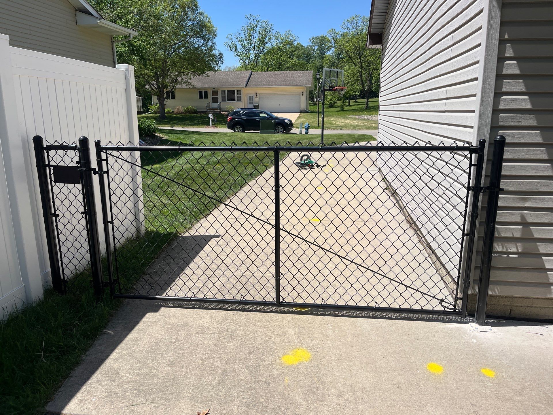 Black Chain Link Fence and Driveway Gate Installation in Waterloo by Perfect Picket Fence and Stain