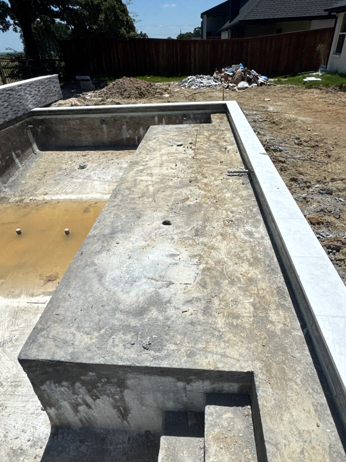 Geometric Pool with Stacked Stone Water Wall by Pinnacle Pools and Spas - DFW