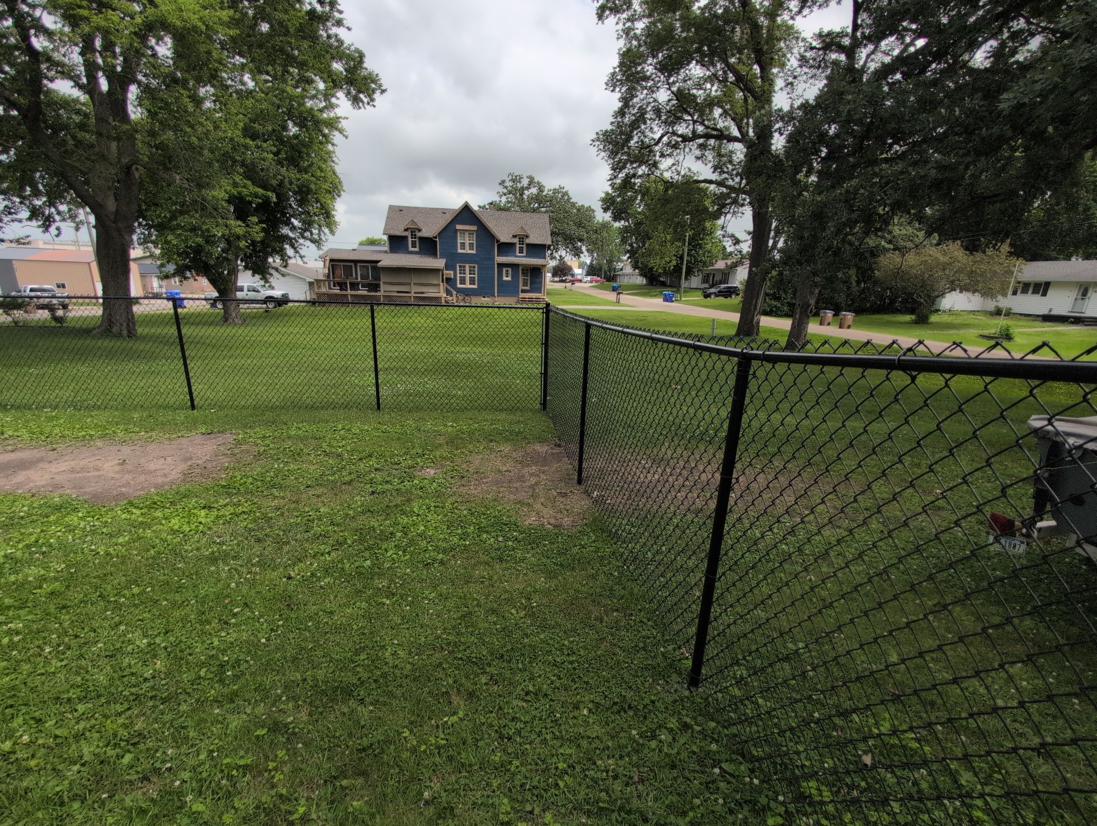 Black Vinyl Coated Chain Link Fence Installation in Independence by Perfect Picket Fence and Stain