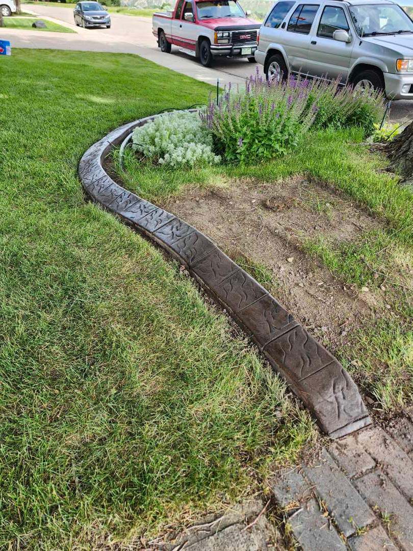 Decorative Stamped Concrete Landscape Edging Installation in Medicine Hat by Pump it Up Concrete Jacking