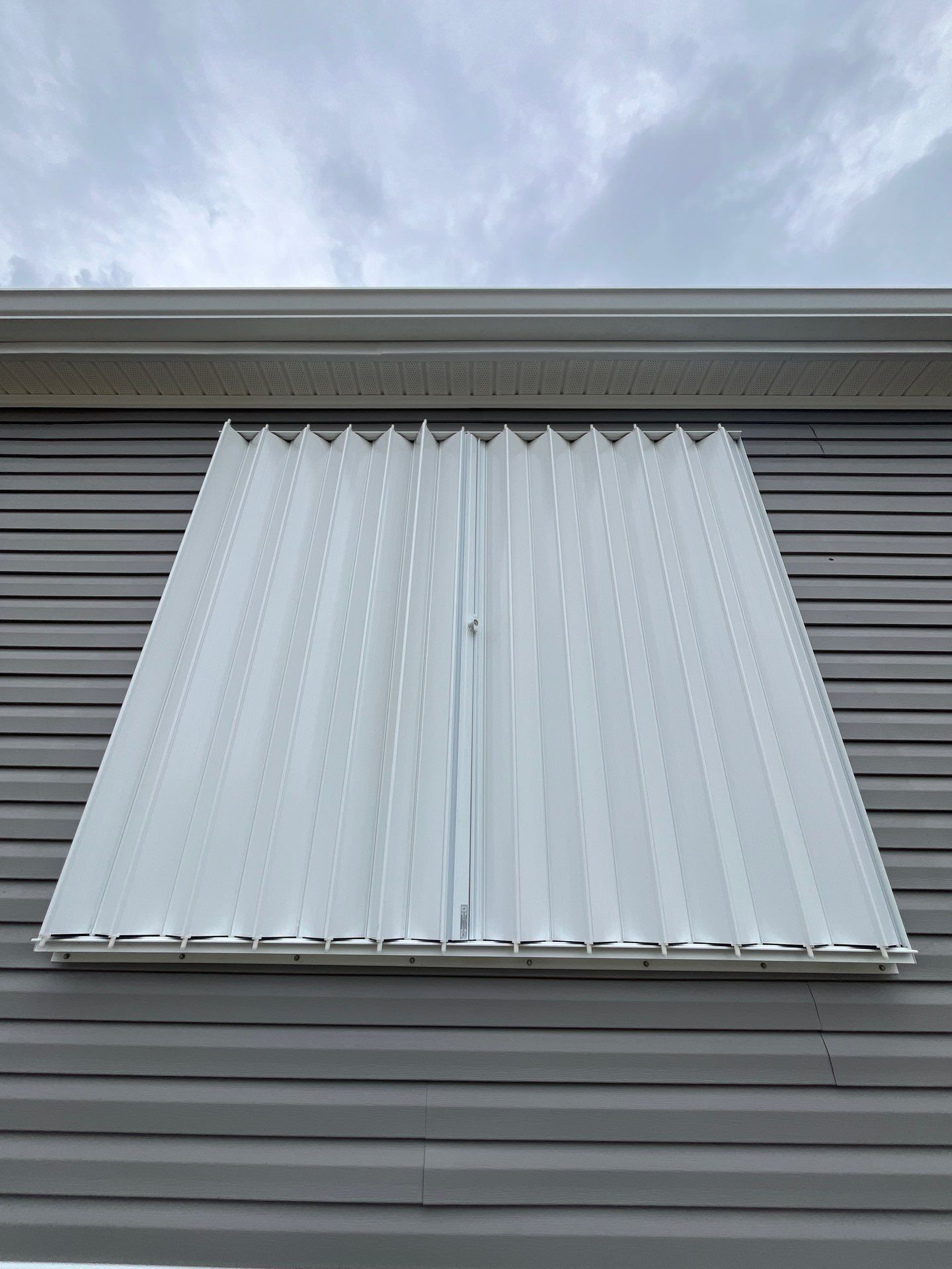 Residential Accordion Hurricane Shutter Installation in Fountain, Florida by Brannan Aluminum Inc.
