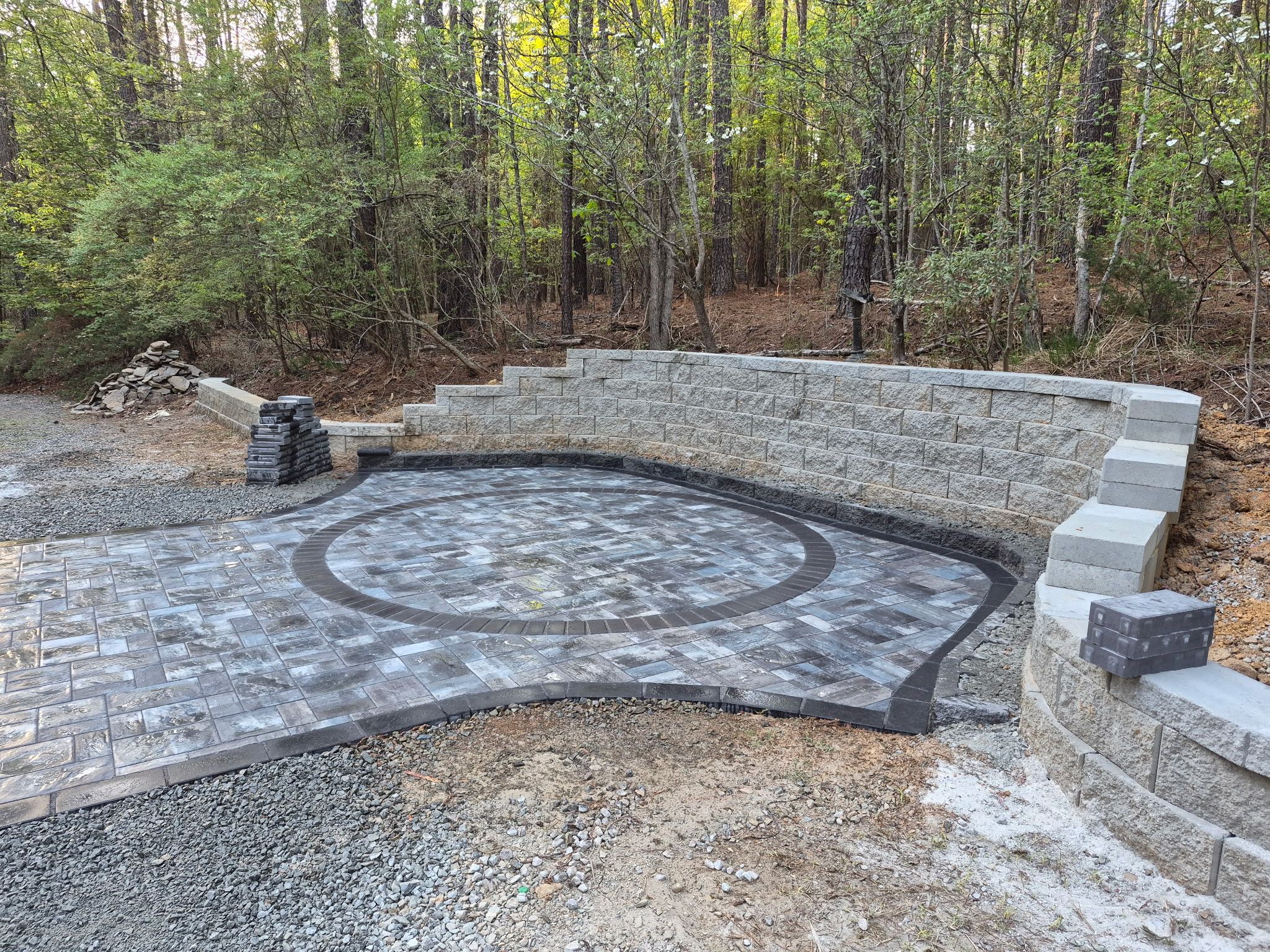 Pittsboro Outdoor Living Transformation – Retaining Wall, Paver Patio & Elevated Deck by Elite Remodeling and Design LLC