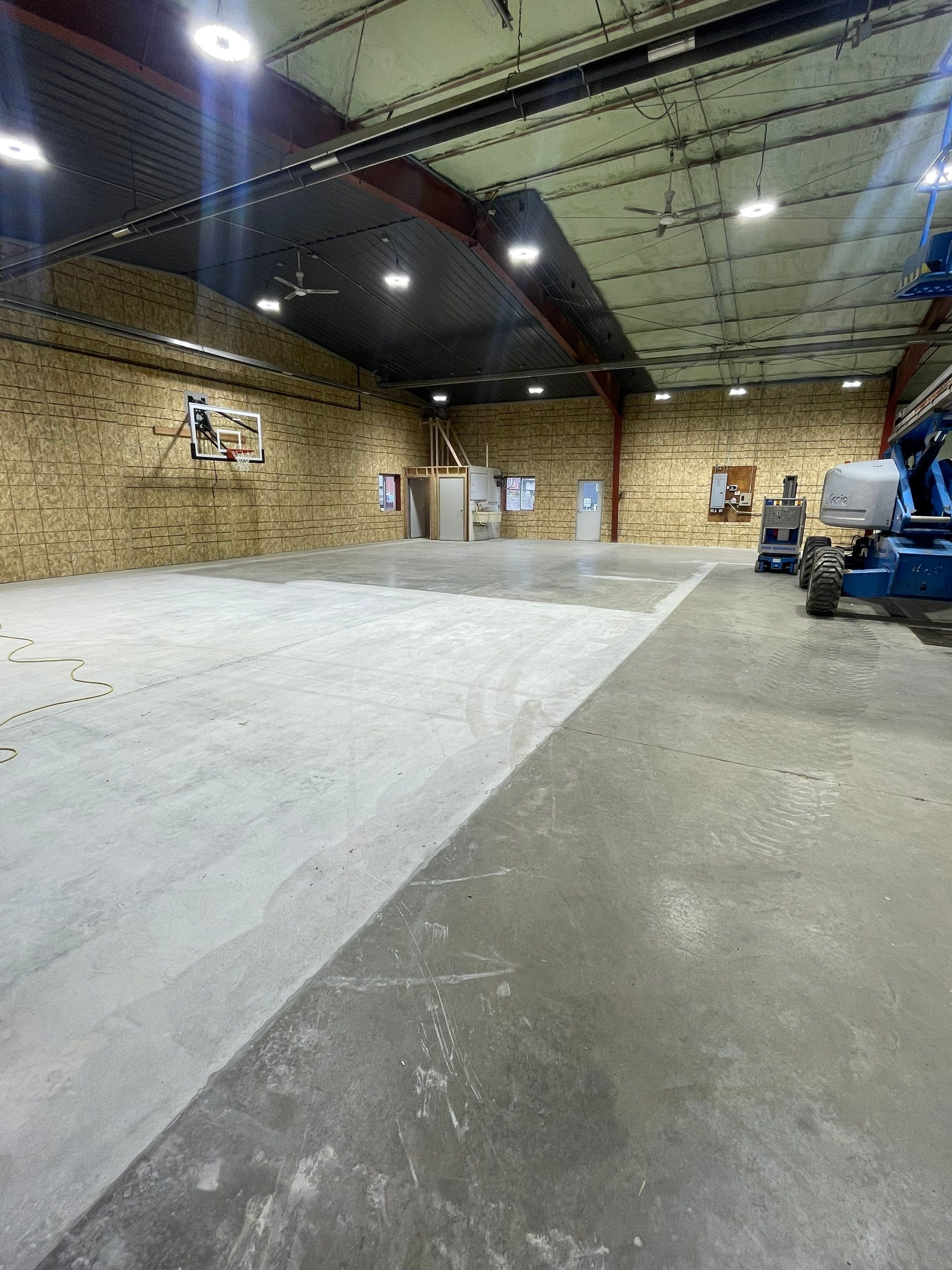 Custom Polyurea Shop Floor with Basketball Court Lines in Rock Valley by Select Painting, Coatings & Garage Cabinets