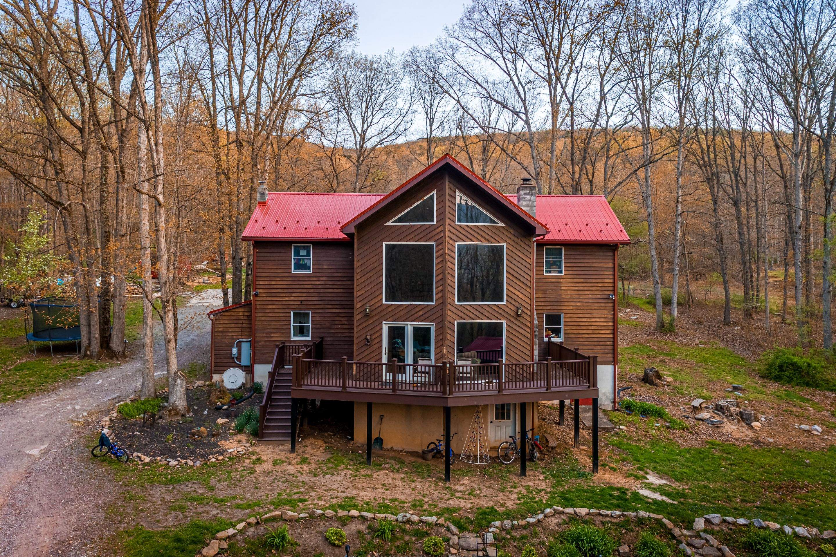 Metal Roof-barn red and new deck by Esh Builders