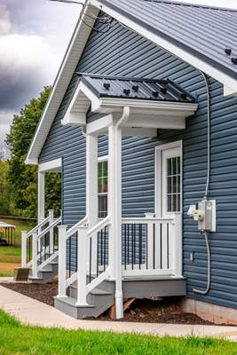 New Residential Addition with Blue Siding and Metal Roofing in Ashland