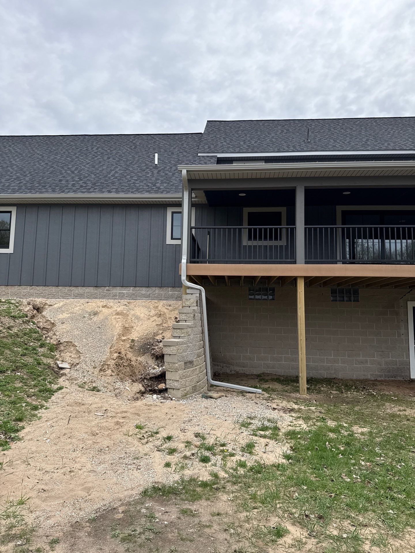White Gutter and Downspout Installation on Modern Kingsley Residence by Rainbow Seamless Systems
