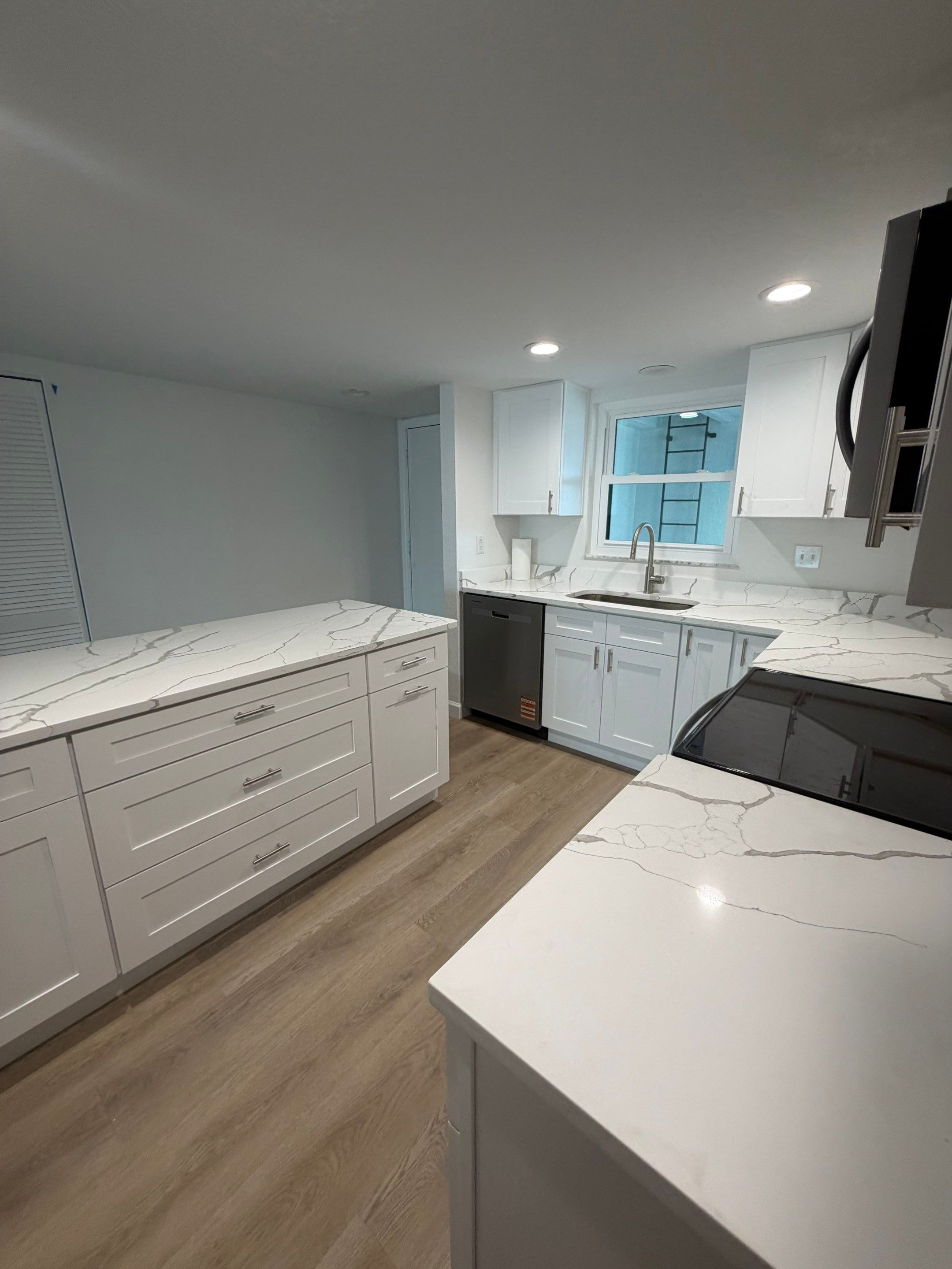 Full Condominium Remodel Featuring Aubrey Oak Flooring In Daytona Beach by Acies Renovations