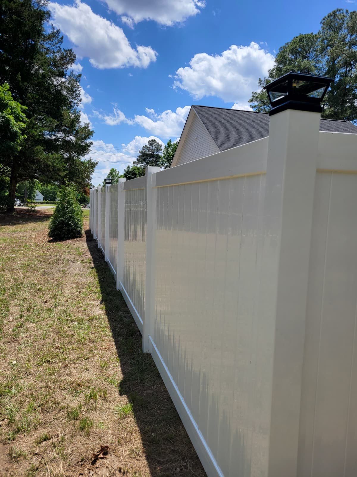 White Vinyl Privacy Fence with Solar Post Caps in Goldsboro by Superior Fence and Rail