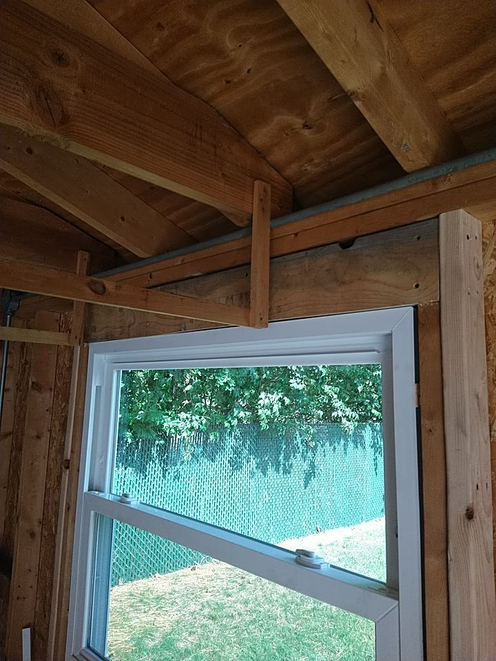 Siding Installation using Norandex woodsman dl-5 white woodgrain vinyl by Absolute Roofing and Construction