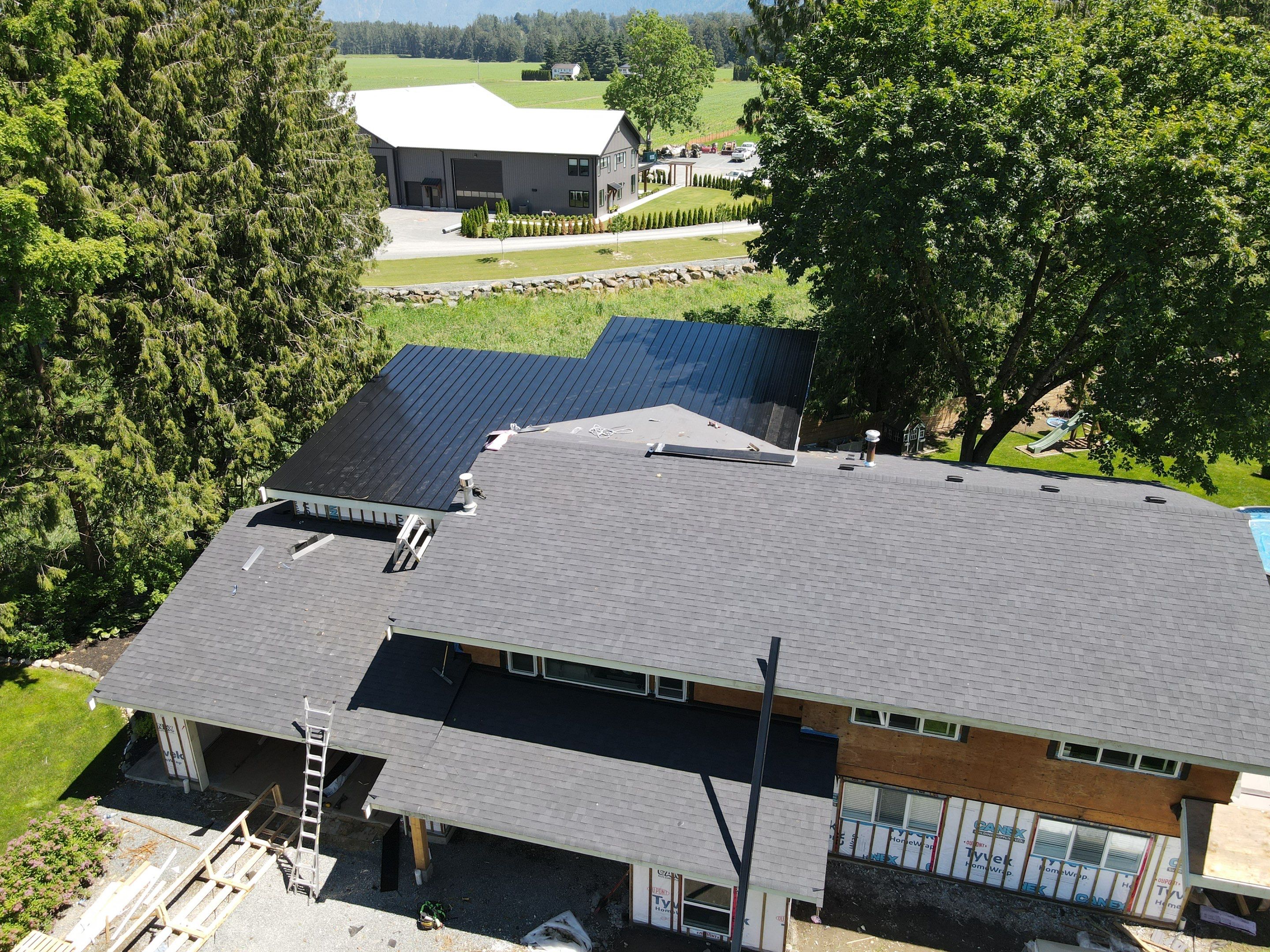 Residential Roofing Installation using 12" Prolok metal, shingles and Torch on roofing by Top Notch Roofing Inc