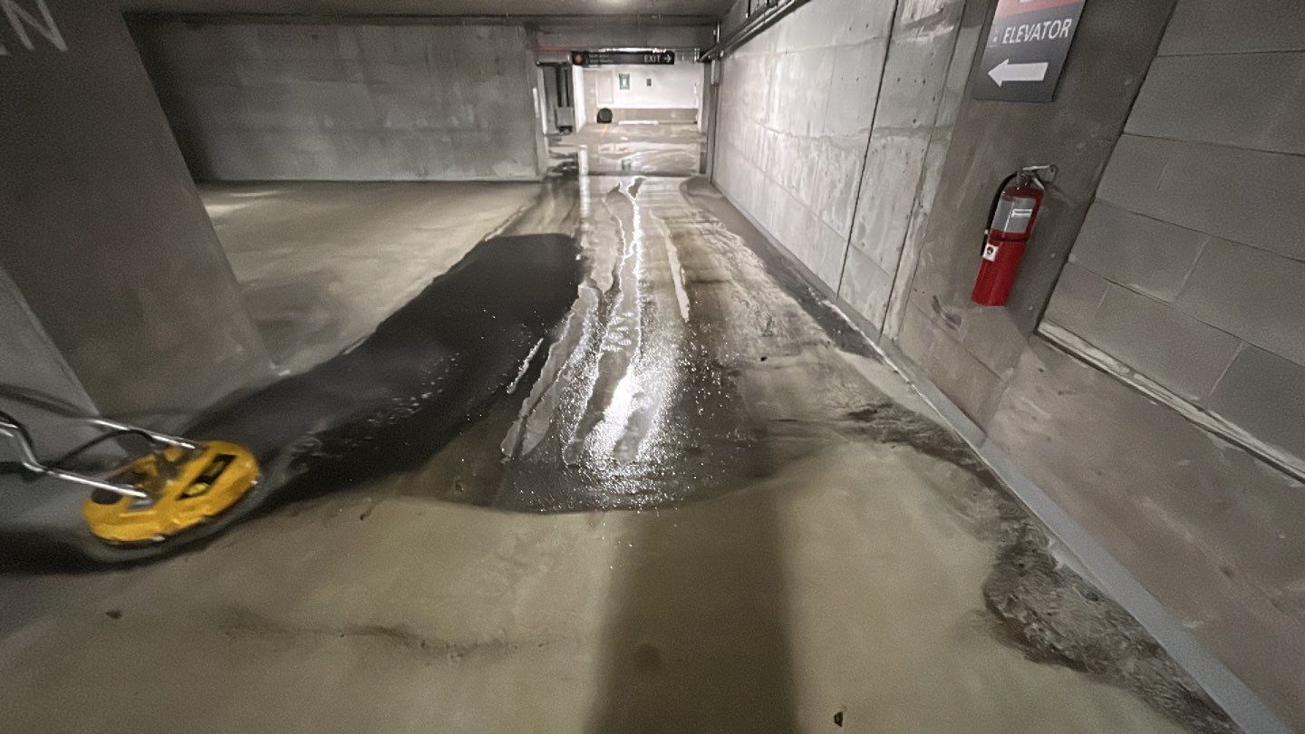 Parking garage using Hot water by Northern Power Washing LLC.