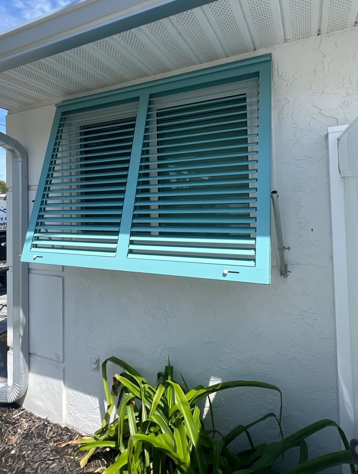 Hurricane Rated Bahama Shutters in Pastel Turquoise  by Smart Guard Shutters