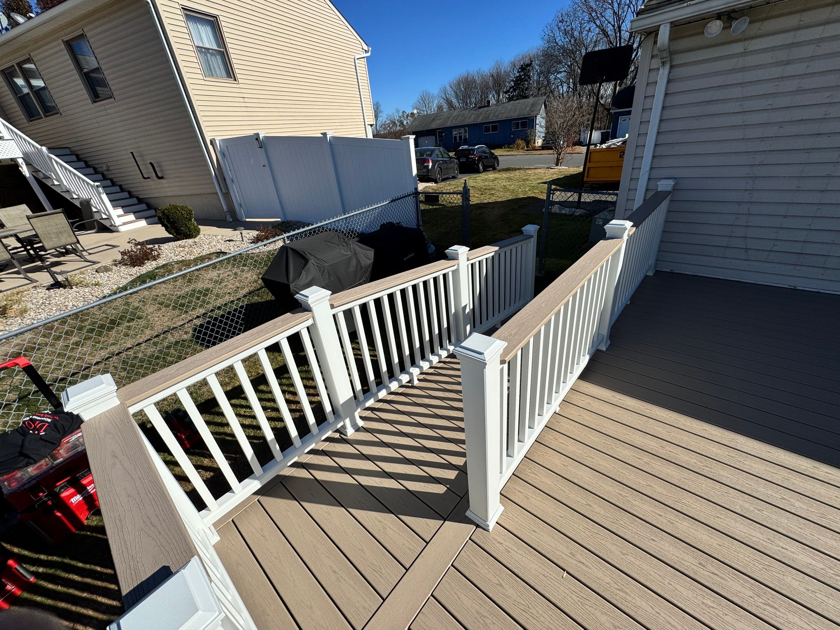 New pool deck and main deck resurface using Trex Transcend Rope Swing boards, White railing and Lattice by DiGiorgi Roofing and Siding Inc