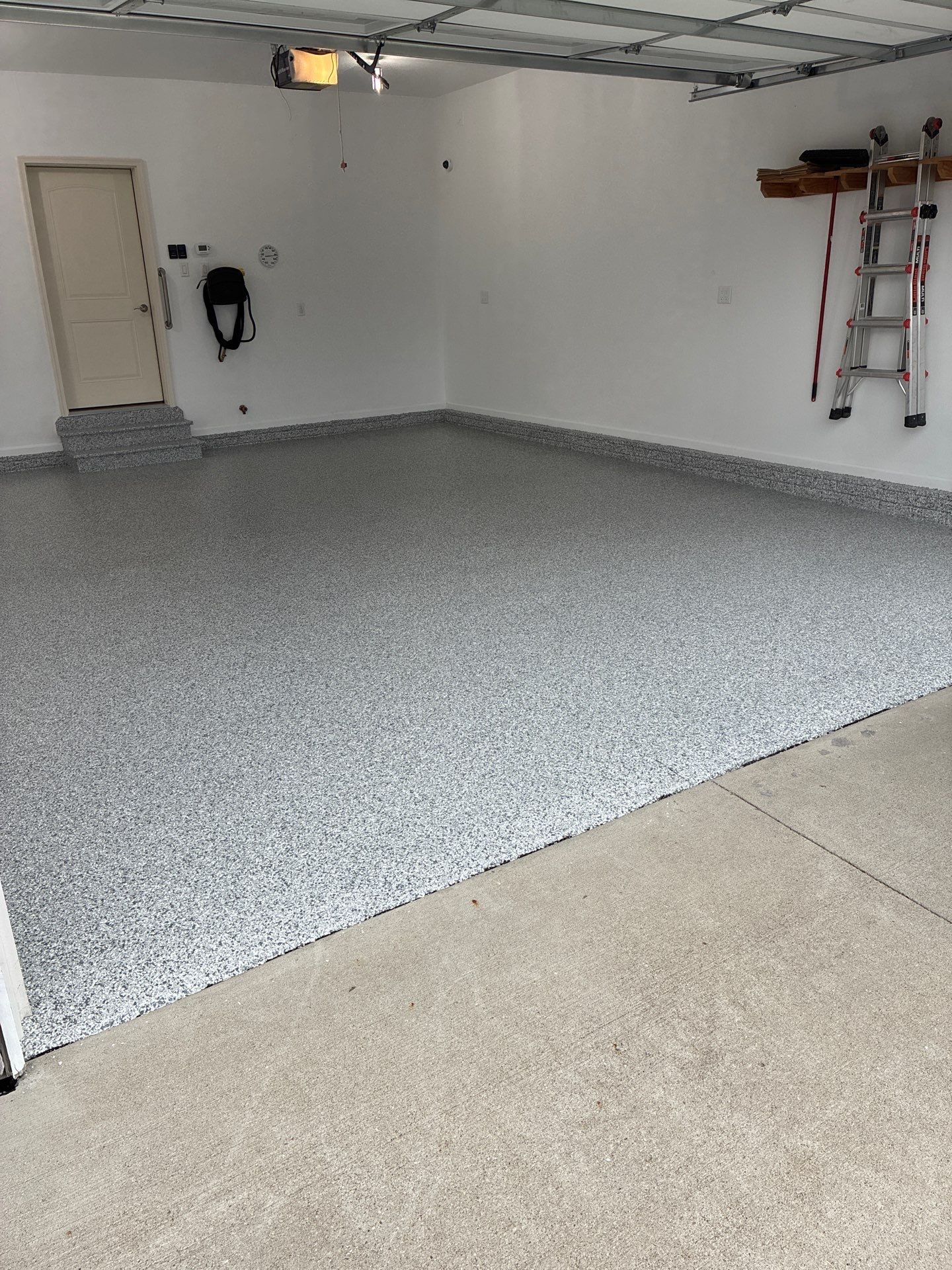 Gray Speckled Epoxy Garage Floor Coating in Grimes by Revival Concrete Coatings