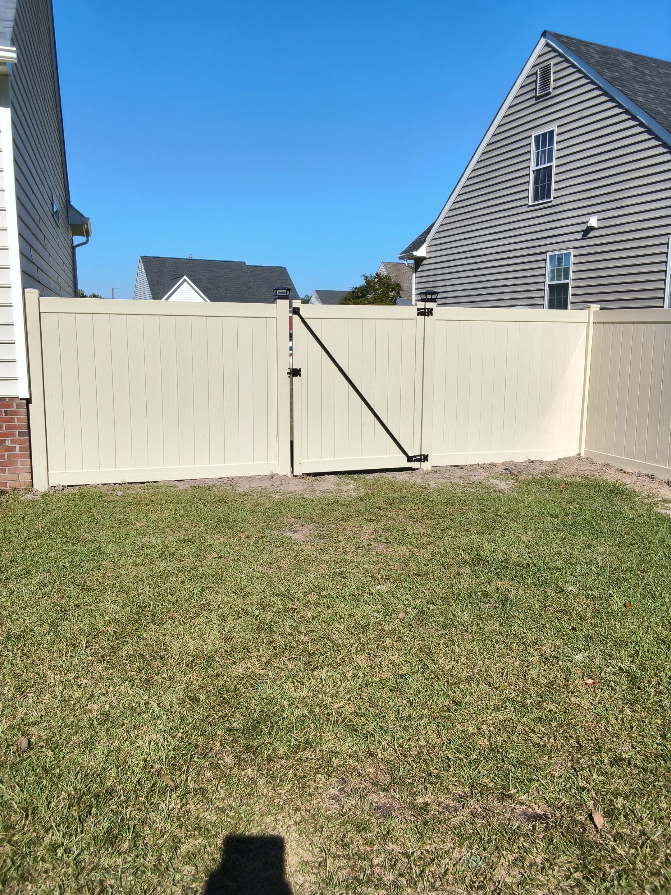 Custom Tan Vinyl Privacy Fence Installation with Double Gates in Winterville by Superior Fence and Rail