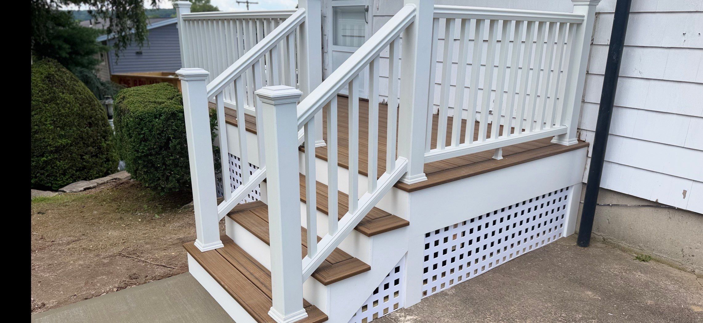 Deck Replacement using Trex Tropical Havana Gold and Transcend White Railings and white lattice by DiGiorgi Roofing and Siding Inc