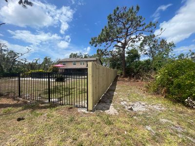 Black Aluminum 3 Rail Fence and Treated Wood Board on Board Privacy Fence