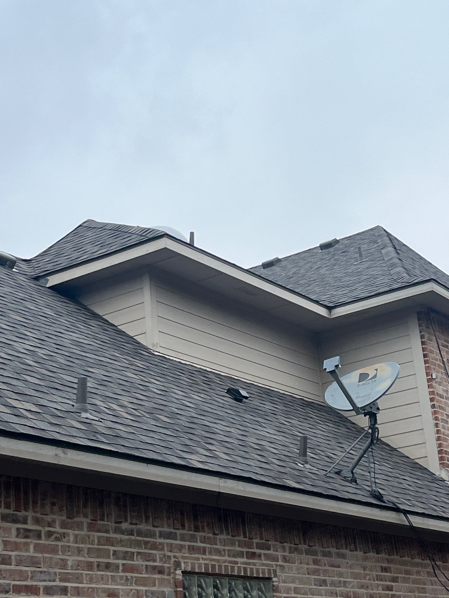 Light red brick/cream stone/espresso shutters with IKO Cornerstone by Tejas Roofworks + Restoration