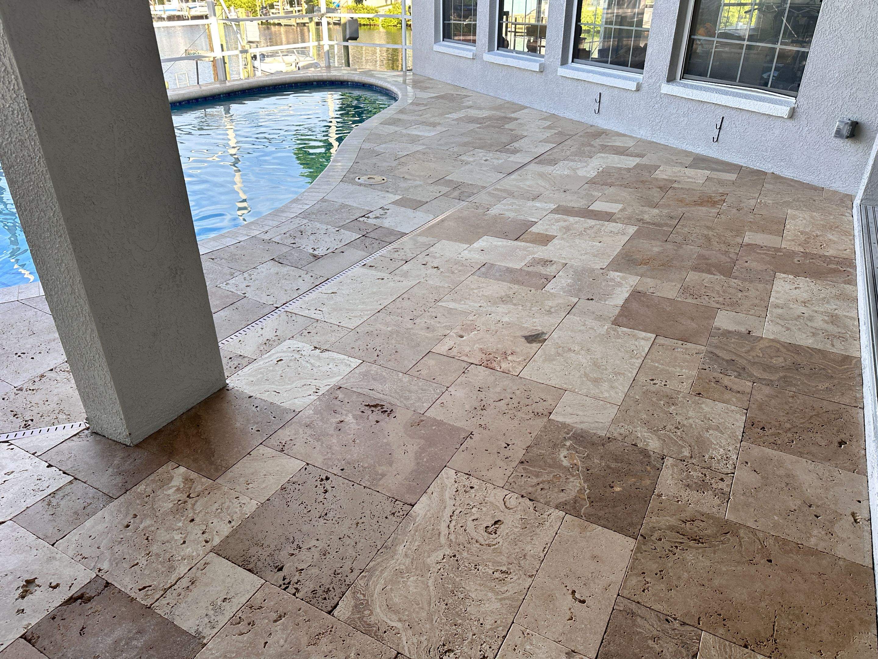 Travertine Sealing and Stripping for a Waterfront Pool Deck in Apollo Beach by Supreme Paver Experts