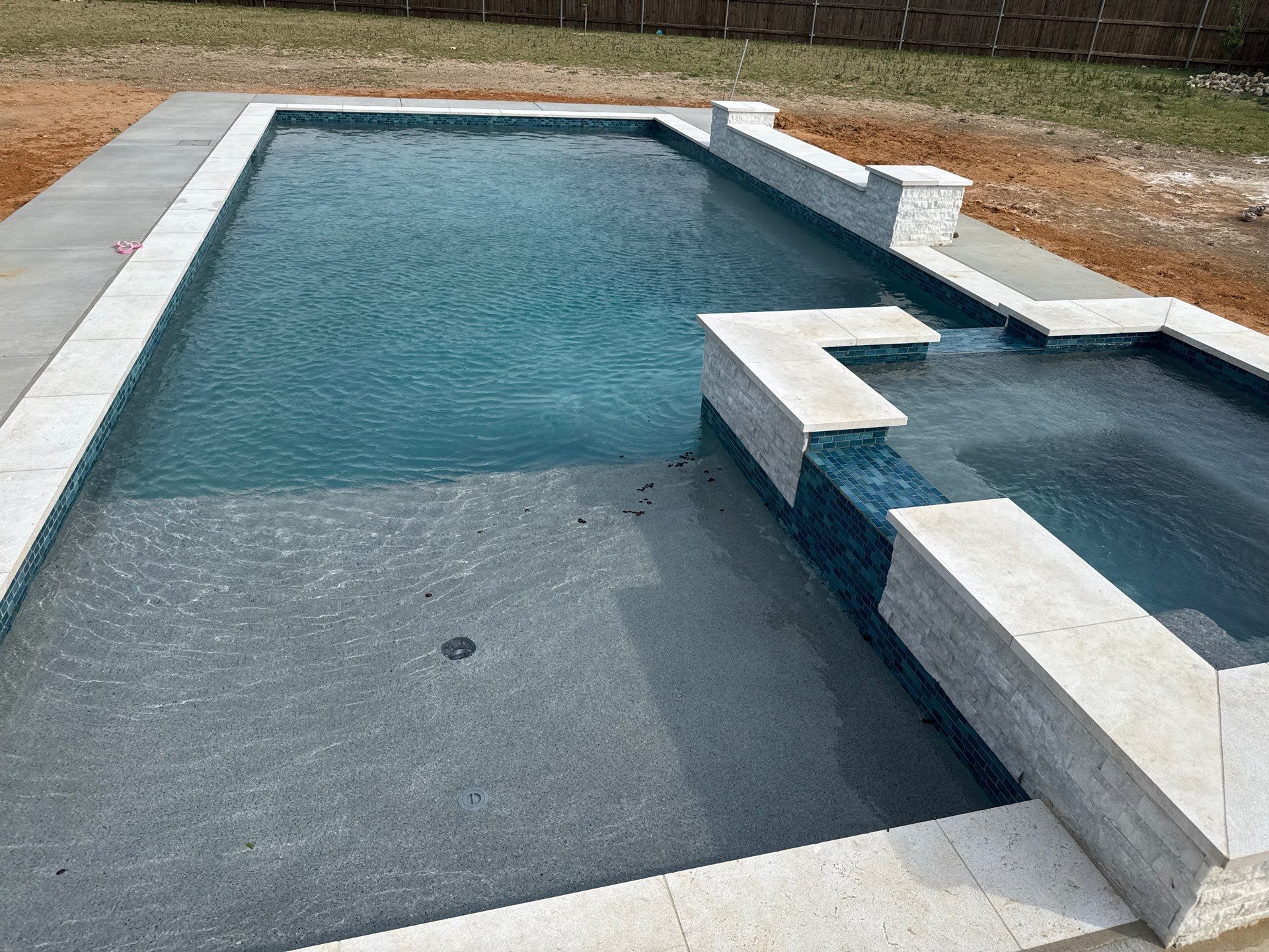 Geometric Pool with Elevated Spa and Night Lighting by Pinnacle Pools and Spas - DFW