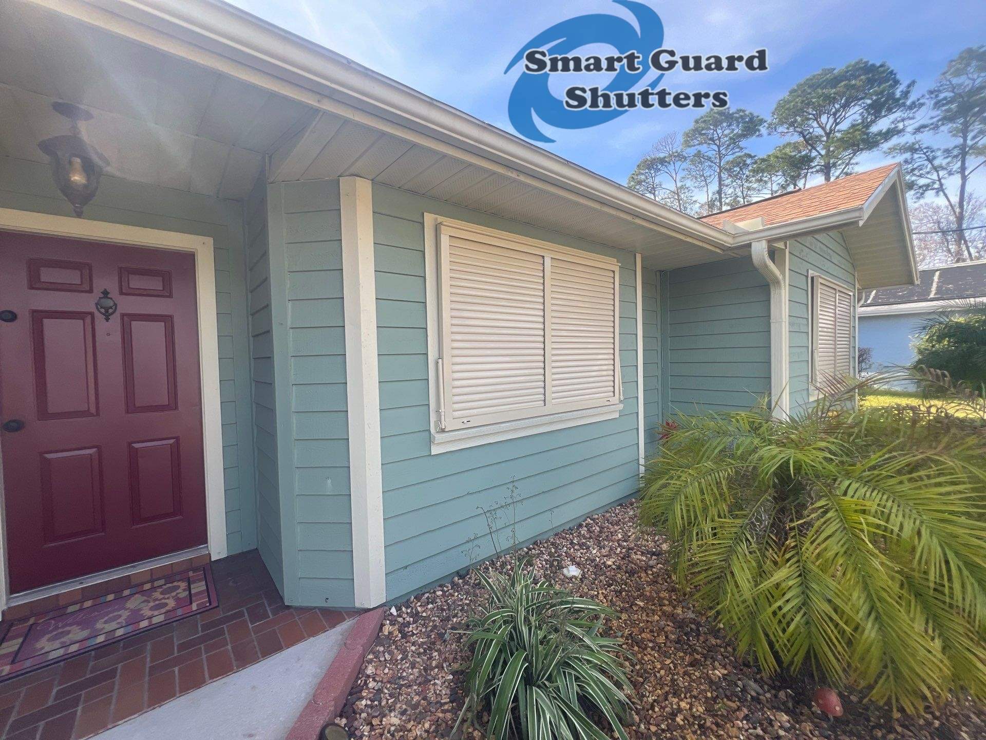 Impact Bahama Shutters in Light Ivory by Smart Guard Shutters