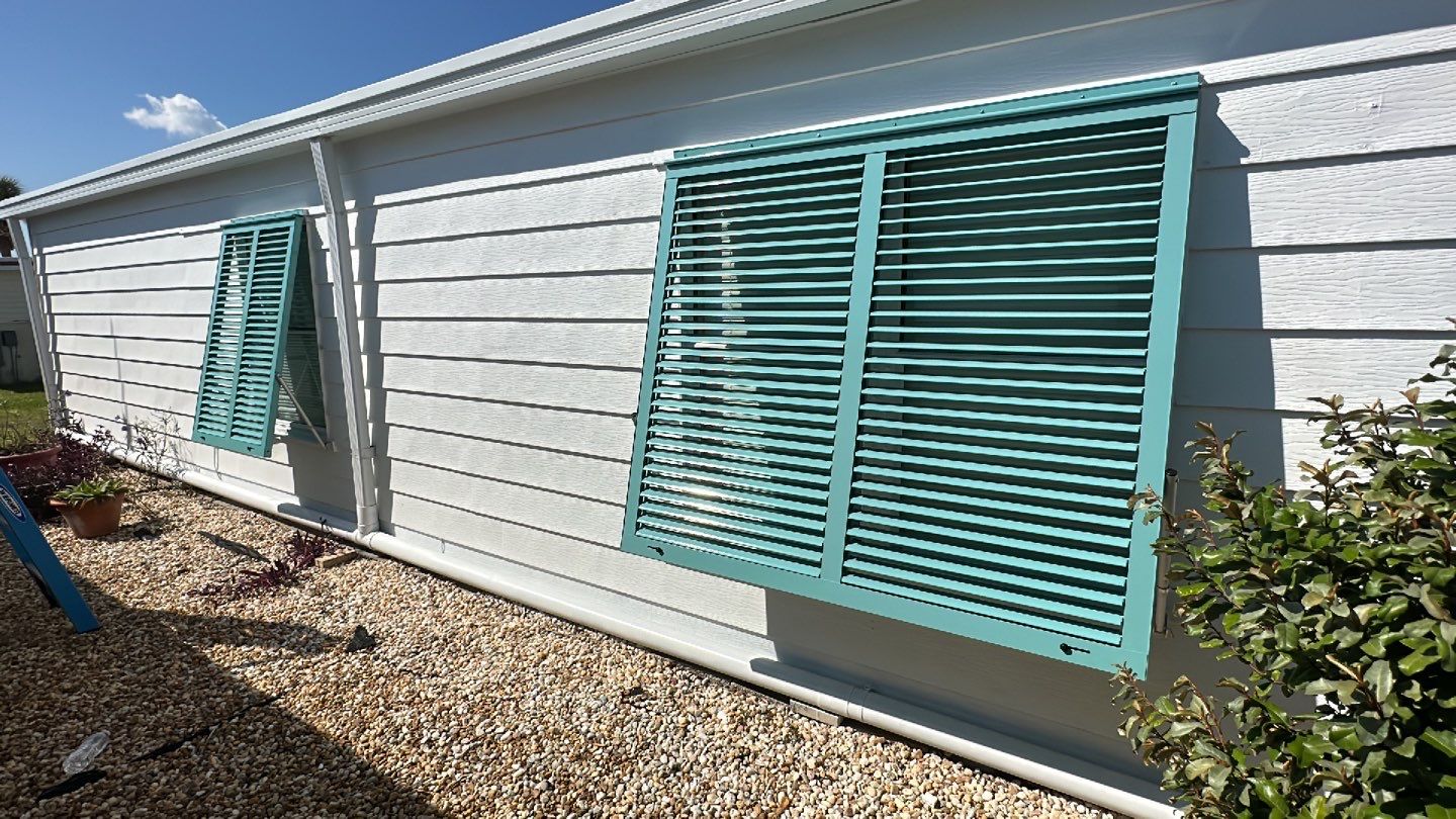 Hurricane Rated Bahama Shutters in Pastel Turquoise by Smart Guard Shutters