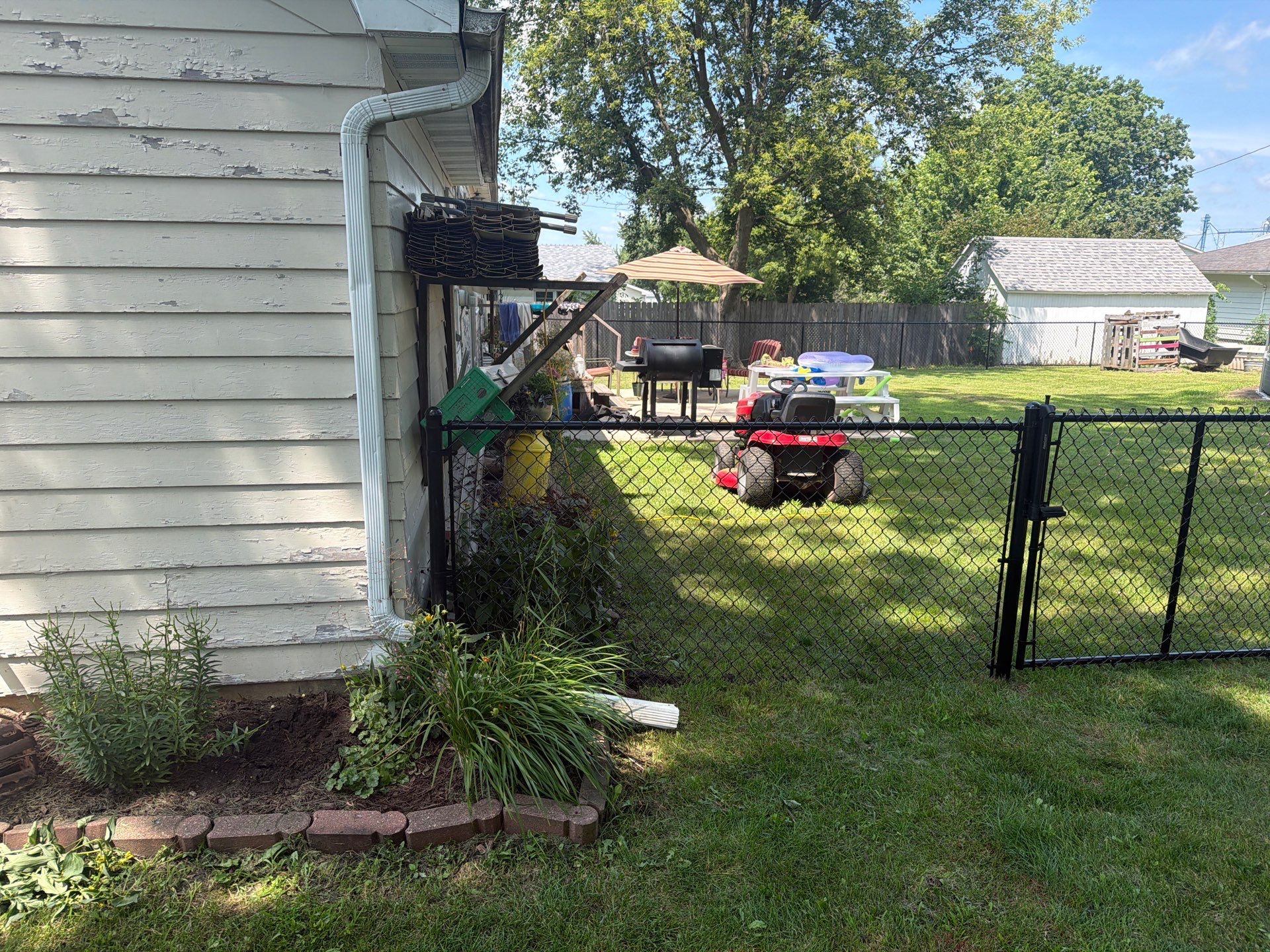 Black Chain Link Backyard Fence Installation in Tripoli, IA by Perfect Picket Fence and Stain