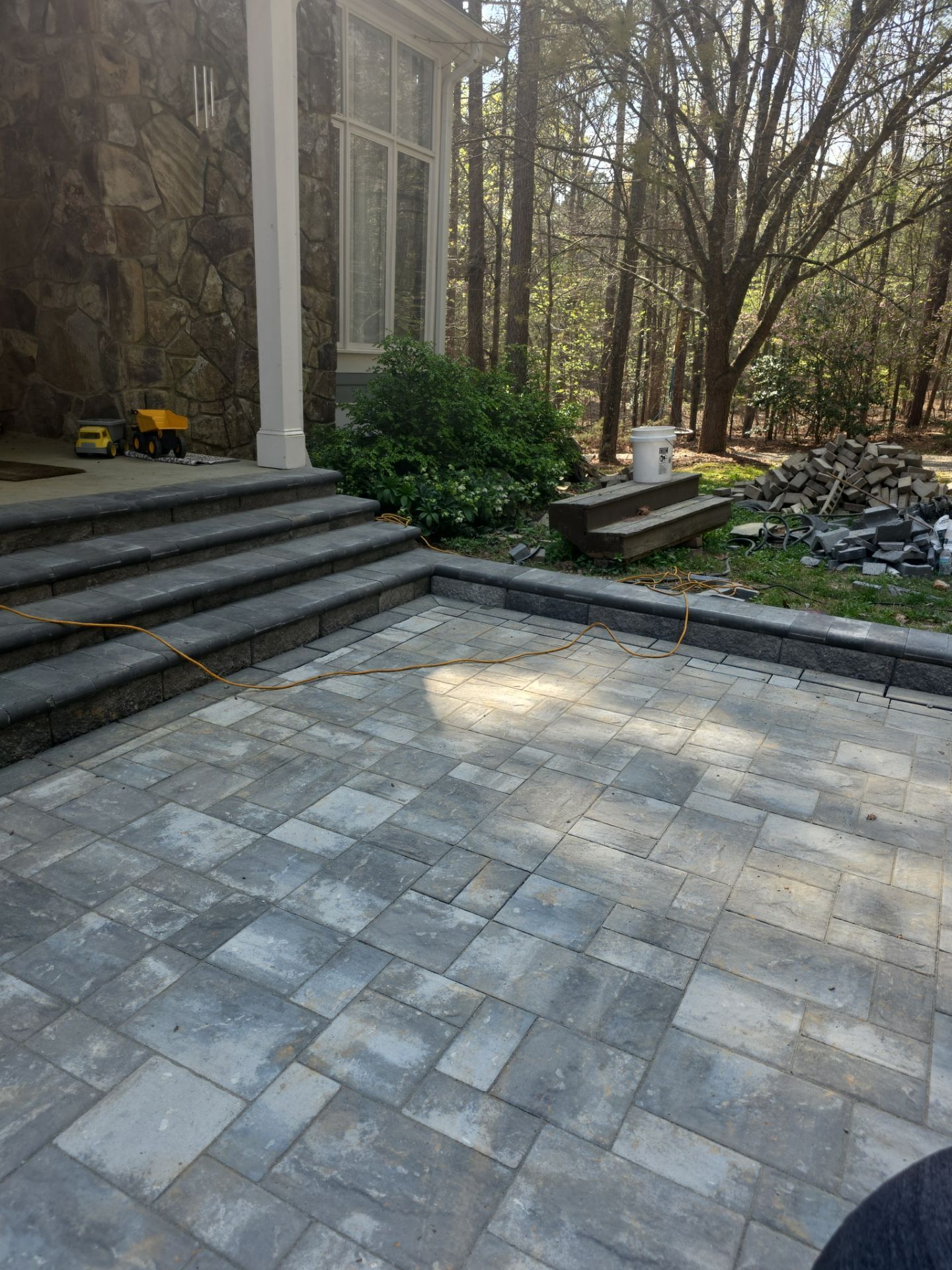 Pittsboro Outdoor Living Transformation – Retaining Wall, Paver Patio & Elevated Deck by Elite Remodeling and Design LLC