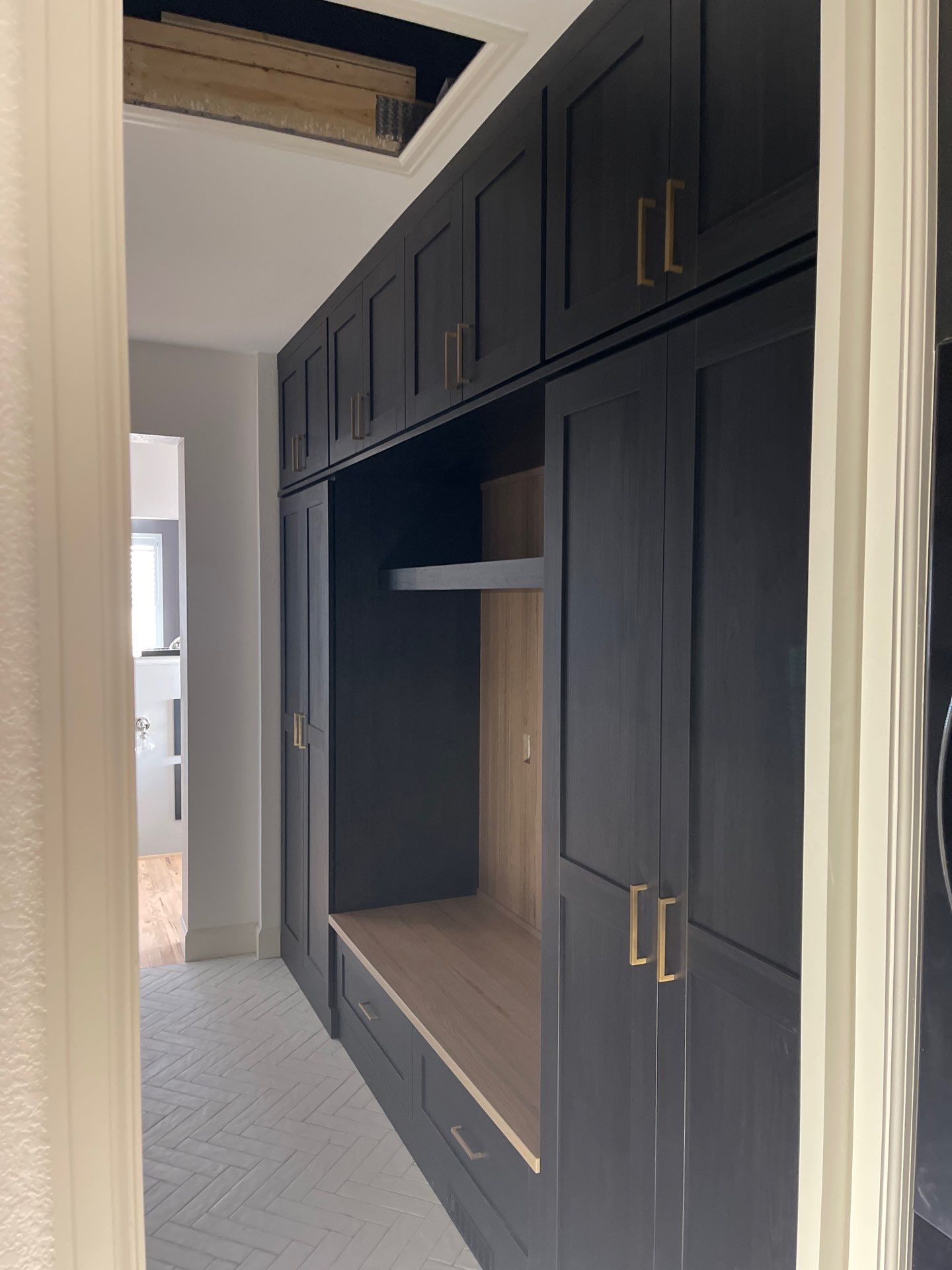 Two-Tone Closet with matching Mudroom + Laundry Room by Concept 32, Inc.