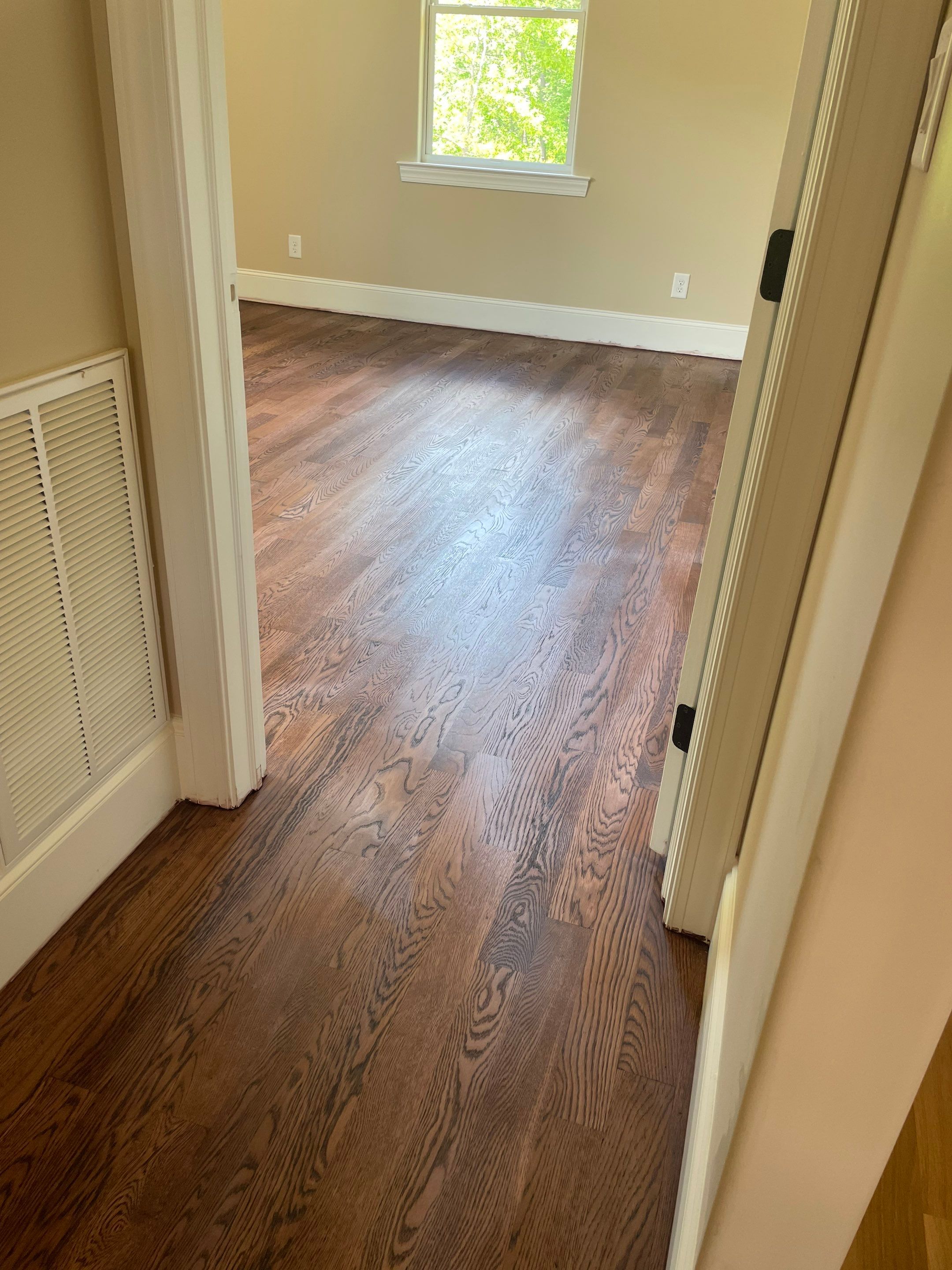 New white oak floors, stained a red tone. by Accent Custom Floors