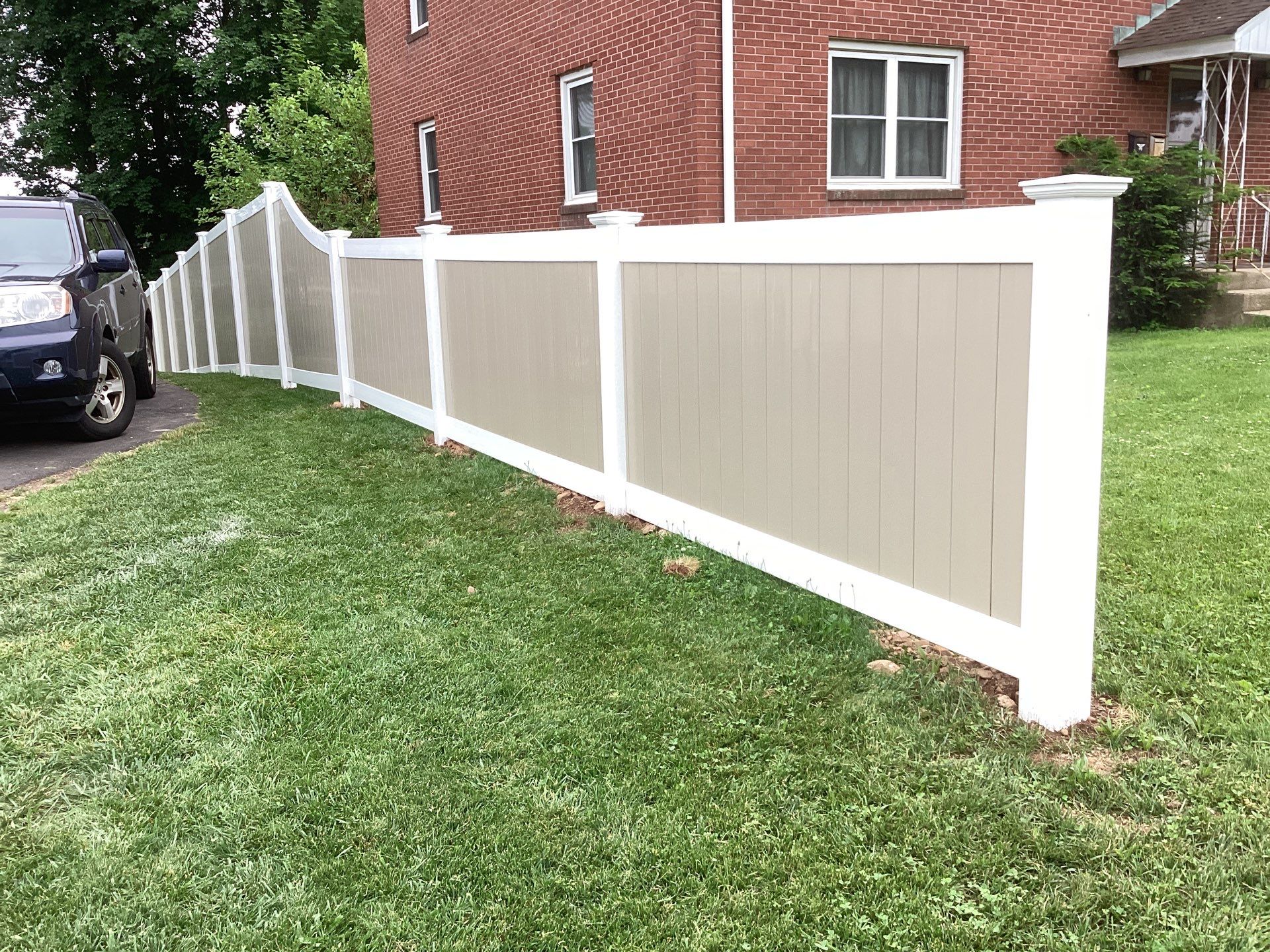 New two tone White and Clay Vinyl privacy fence. by DiGiorgi Roofing and Siding Inc