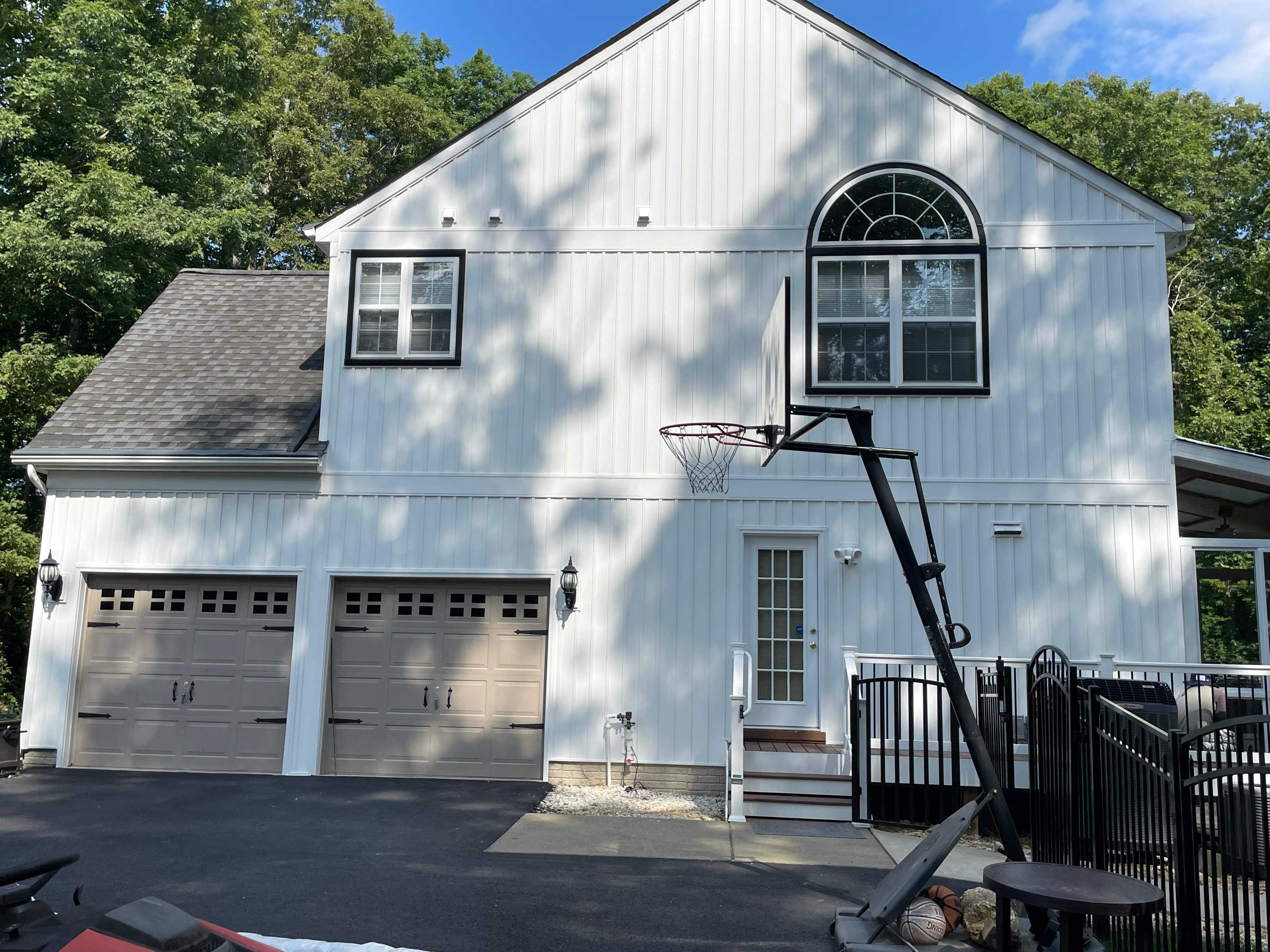 Vinyl Siding Replacement + Black Trim by American Home Contractors
