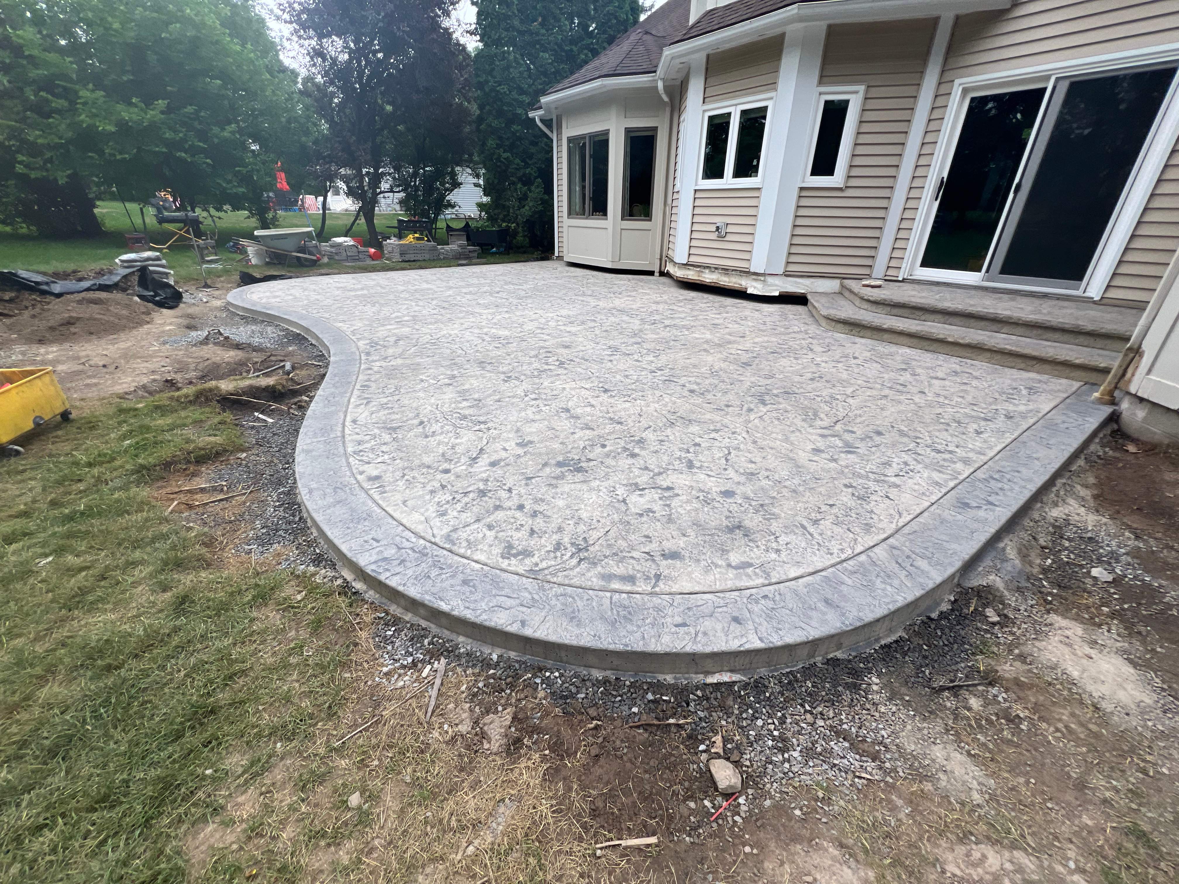 Heavy stone stamped concrete patio and sidewalk  by NG Masonry & Construction LLC