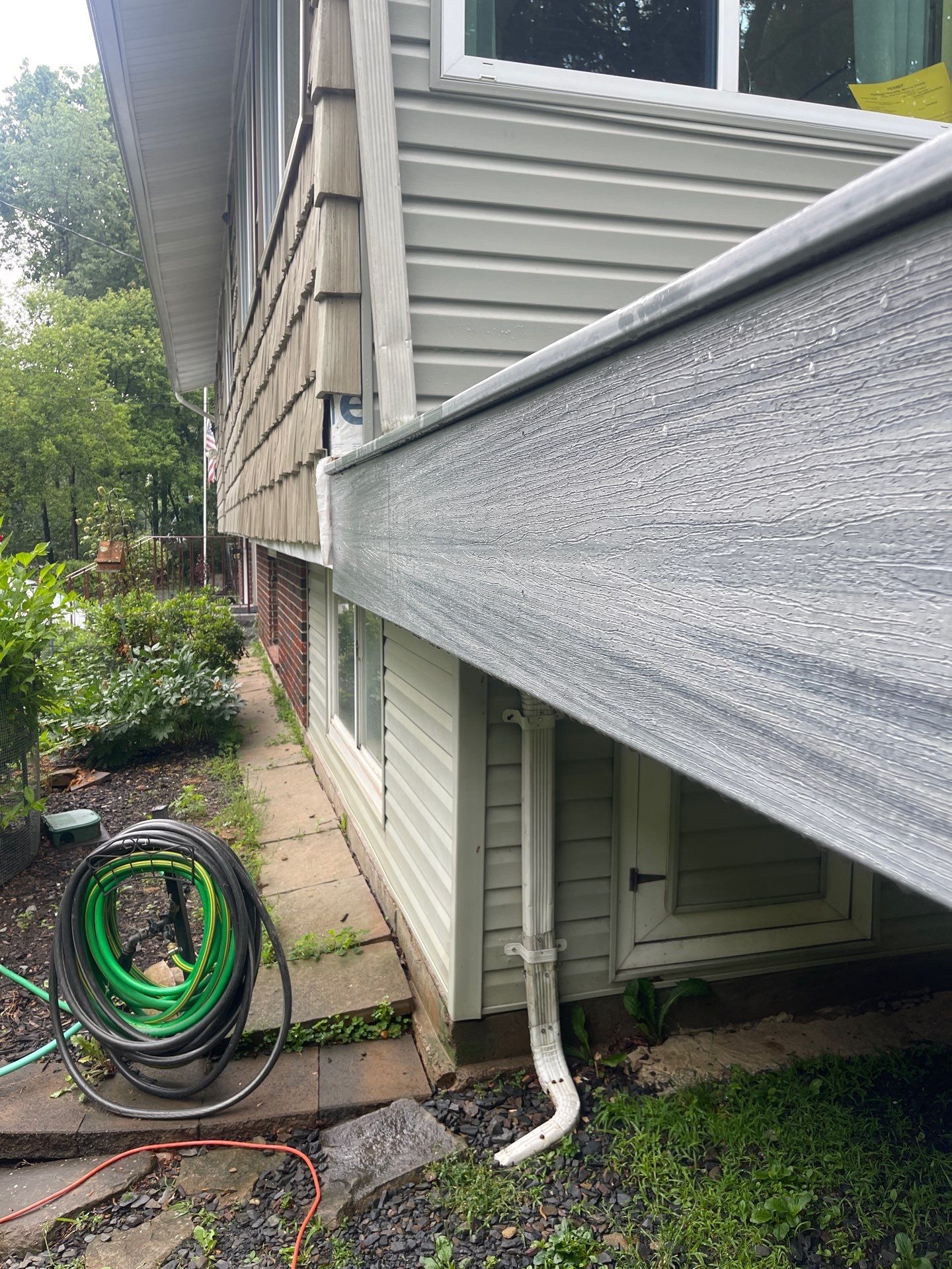 Raised Gray Composite Deck and Staircase Construction in Pocono Summit, PA by Herts Roofing & Construction