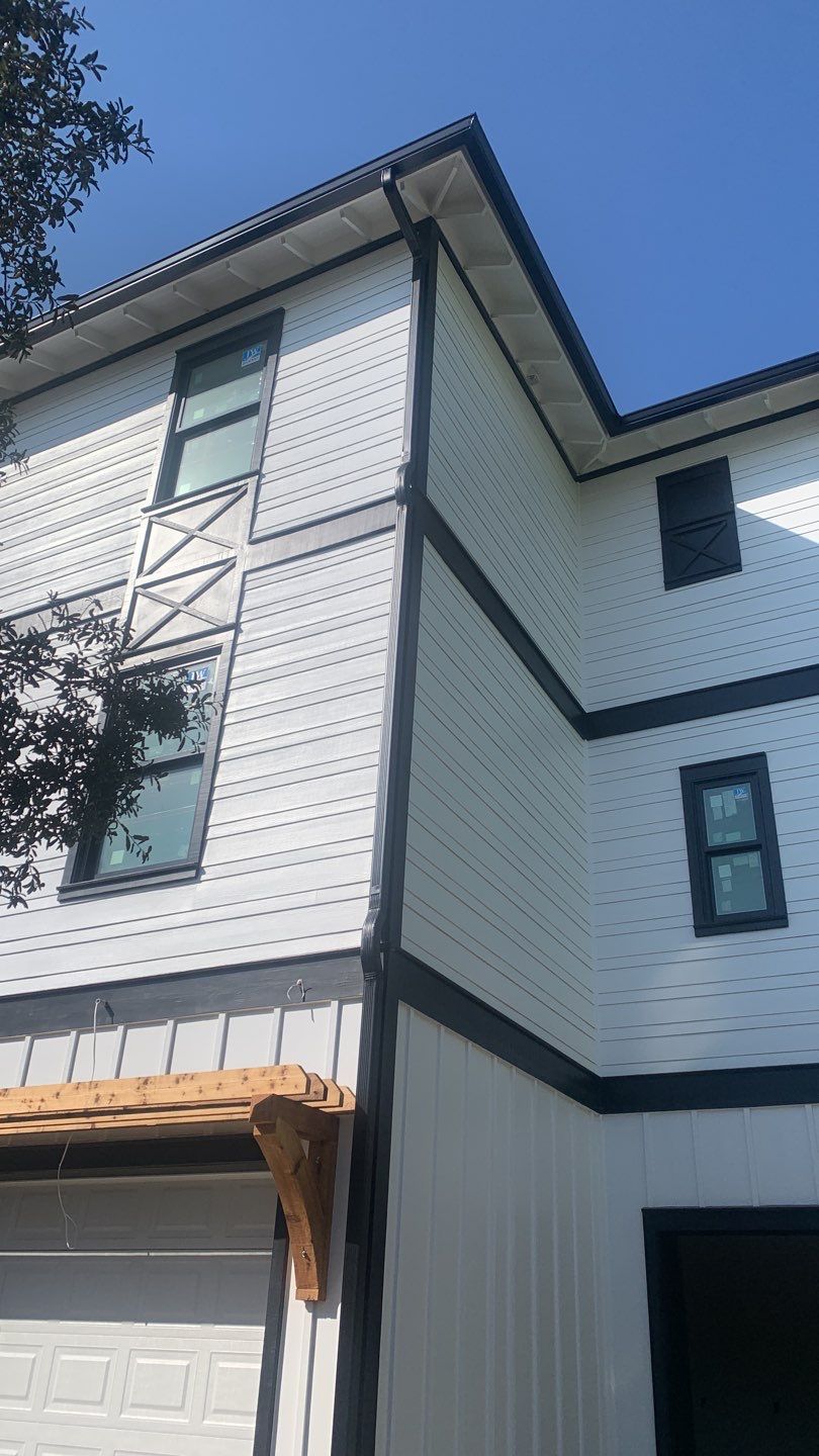Seamless Gutter Installation Using Black Half Round Seamless Gutters by Gutter Professors