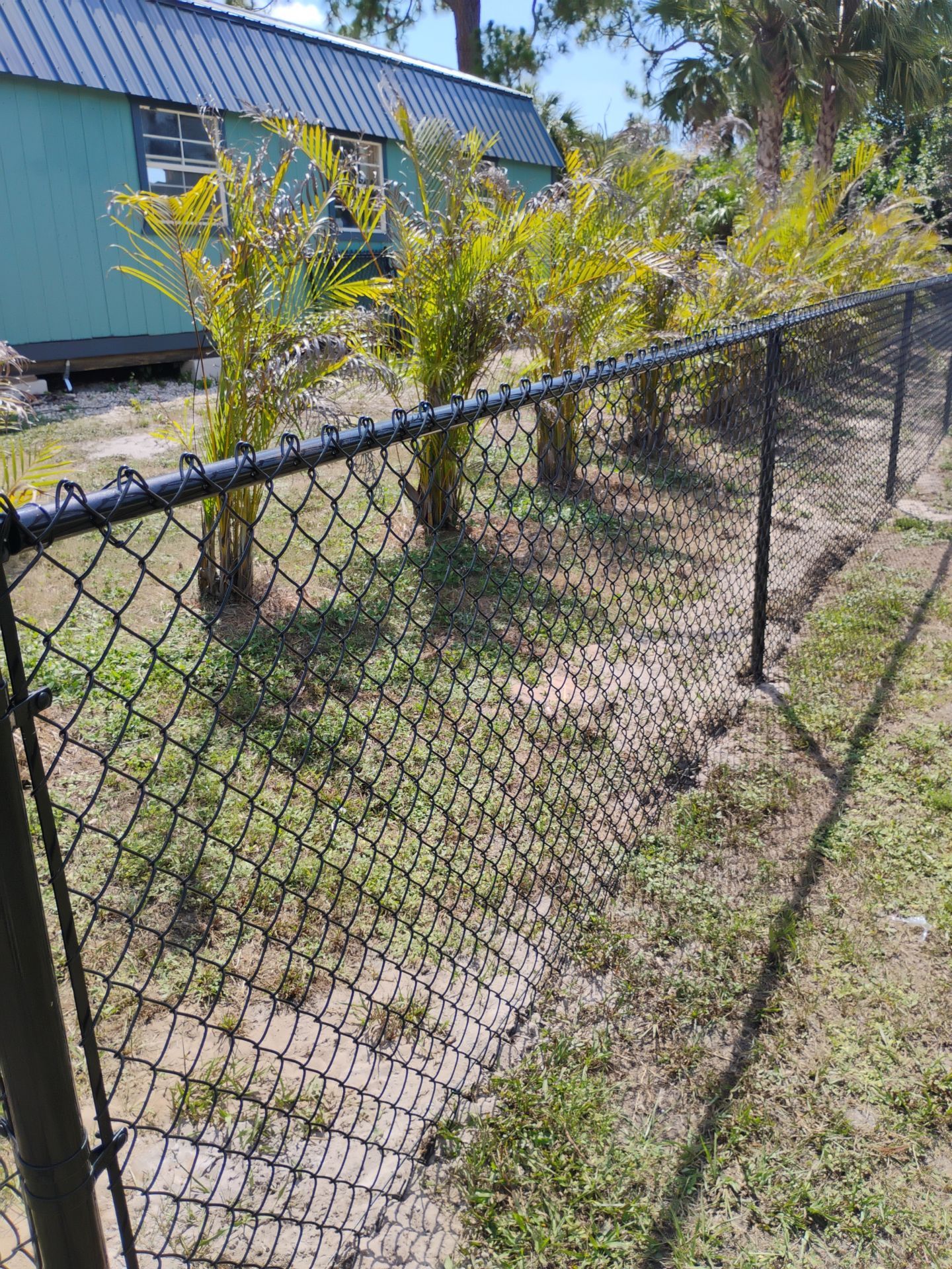 Black Vinyl-Coated Chain Link Fence and Rolling Gate Installation in North Port by True Fence LLC