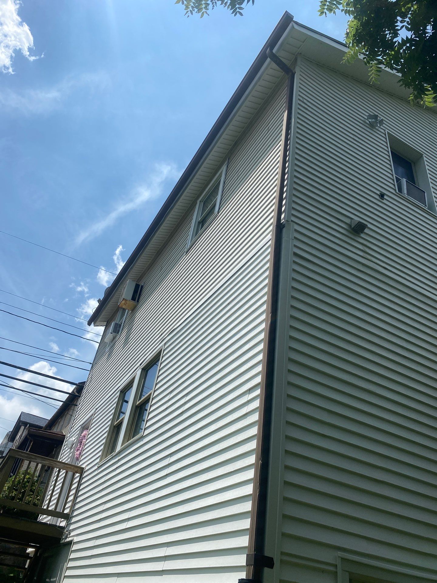 White siding  by Cousins Roofing Siding & Decks