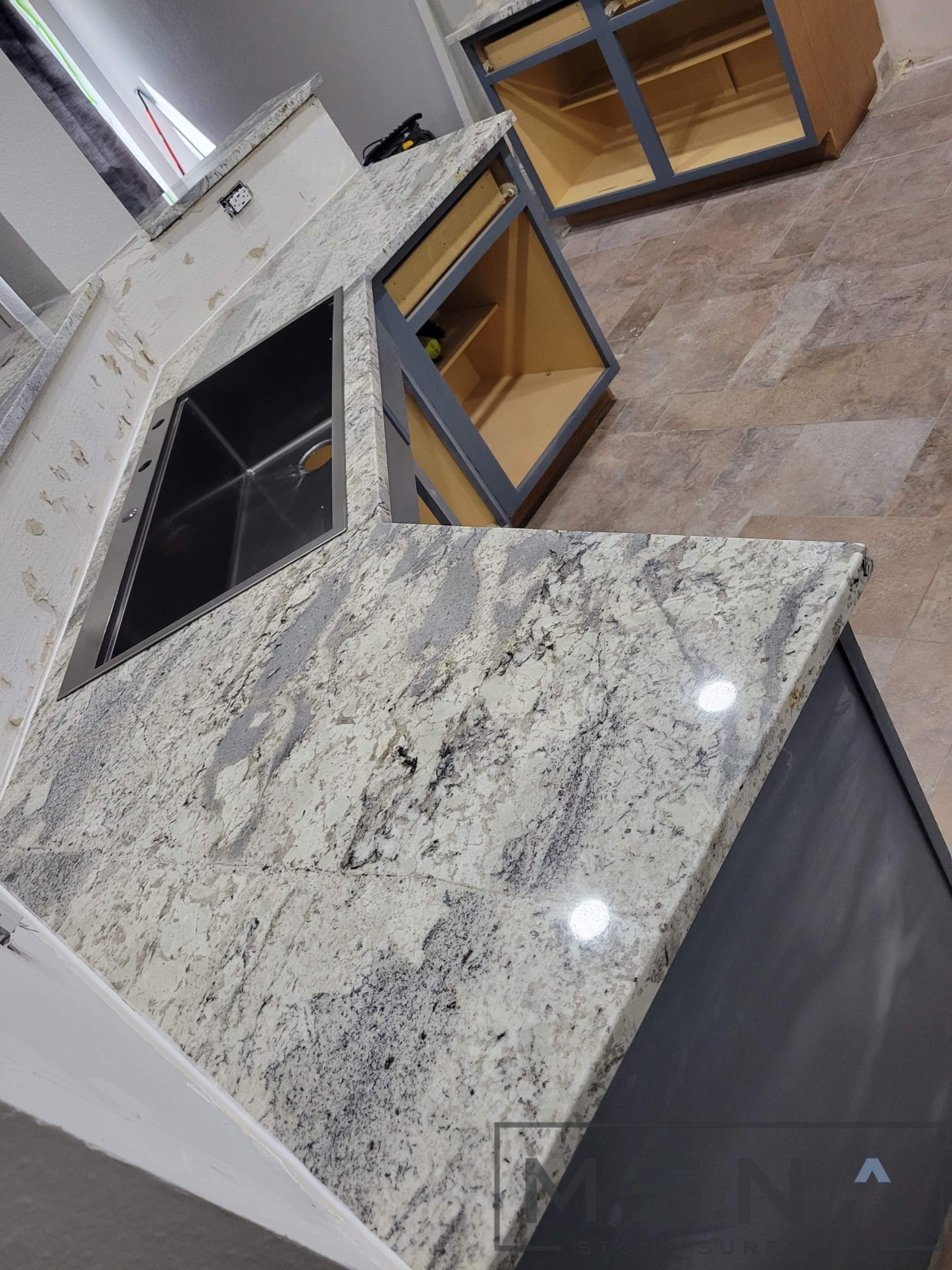 Kitchen countertops using Alaska Blue Granite by Mena stone surfaces