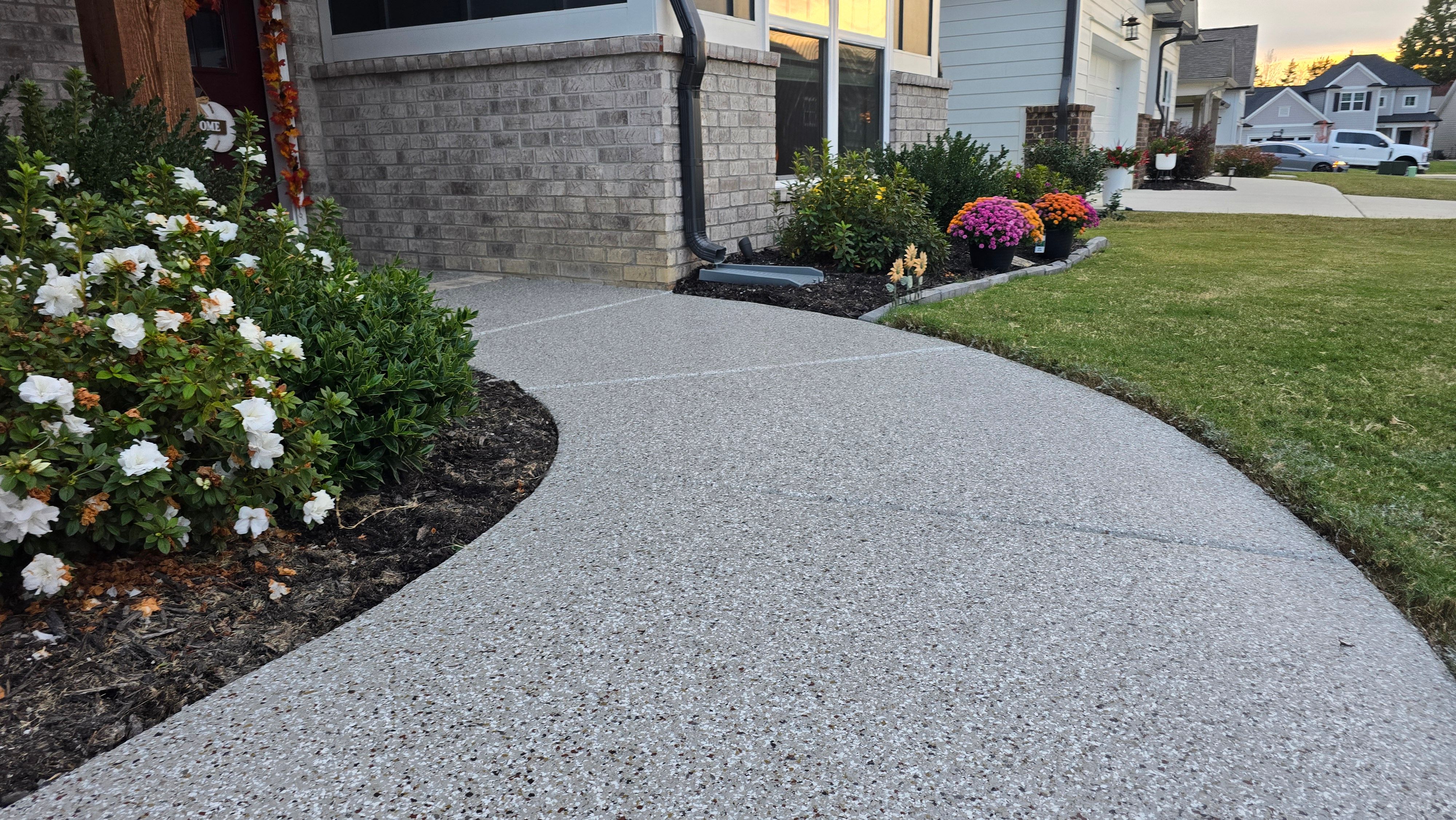 Sidewalk, Porch, and Back Patio Using Creekbed and Nordic Green by Elite Floor Solutions