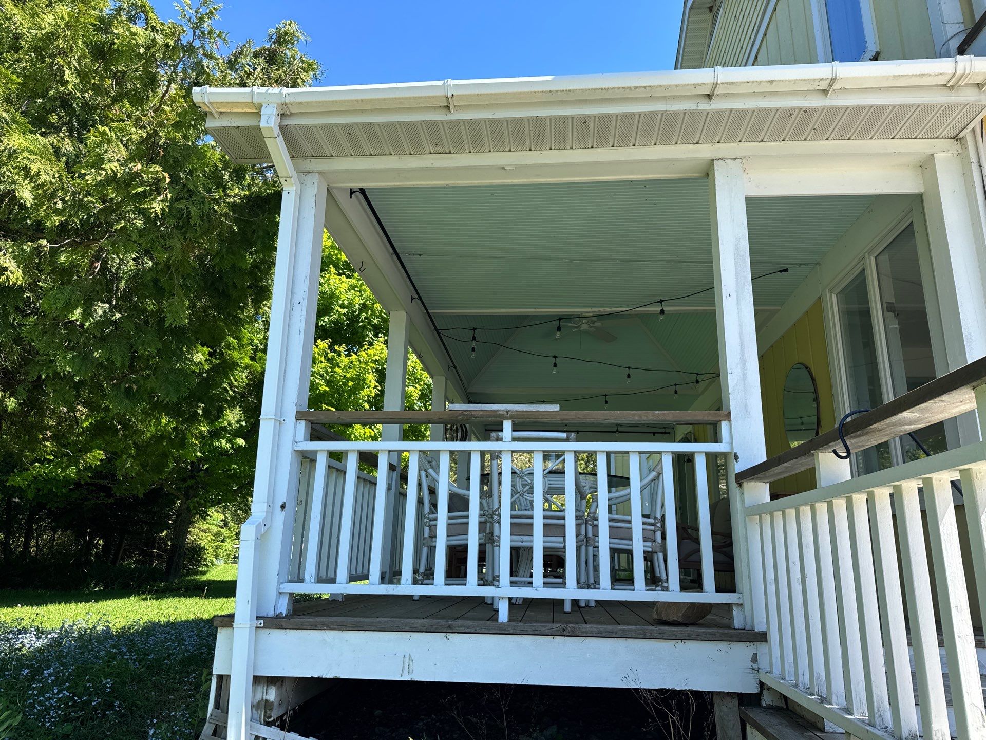 Sunesta motorized Sentry Privacy Screen Installation for Saint Ignace Waterfront Porch by Rainbow Seamless Systems