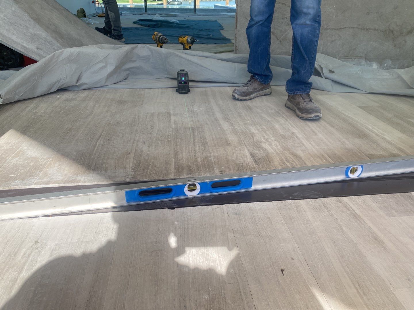 Custom Material Pivot Door installation by Impact Precious Wood Inc.
